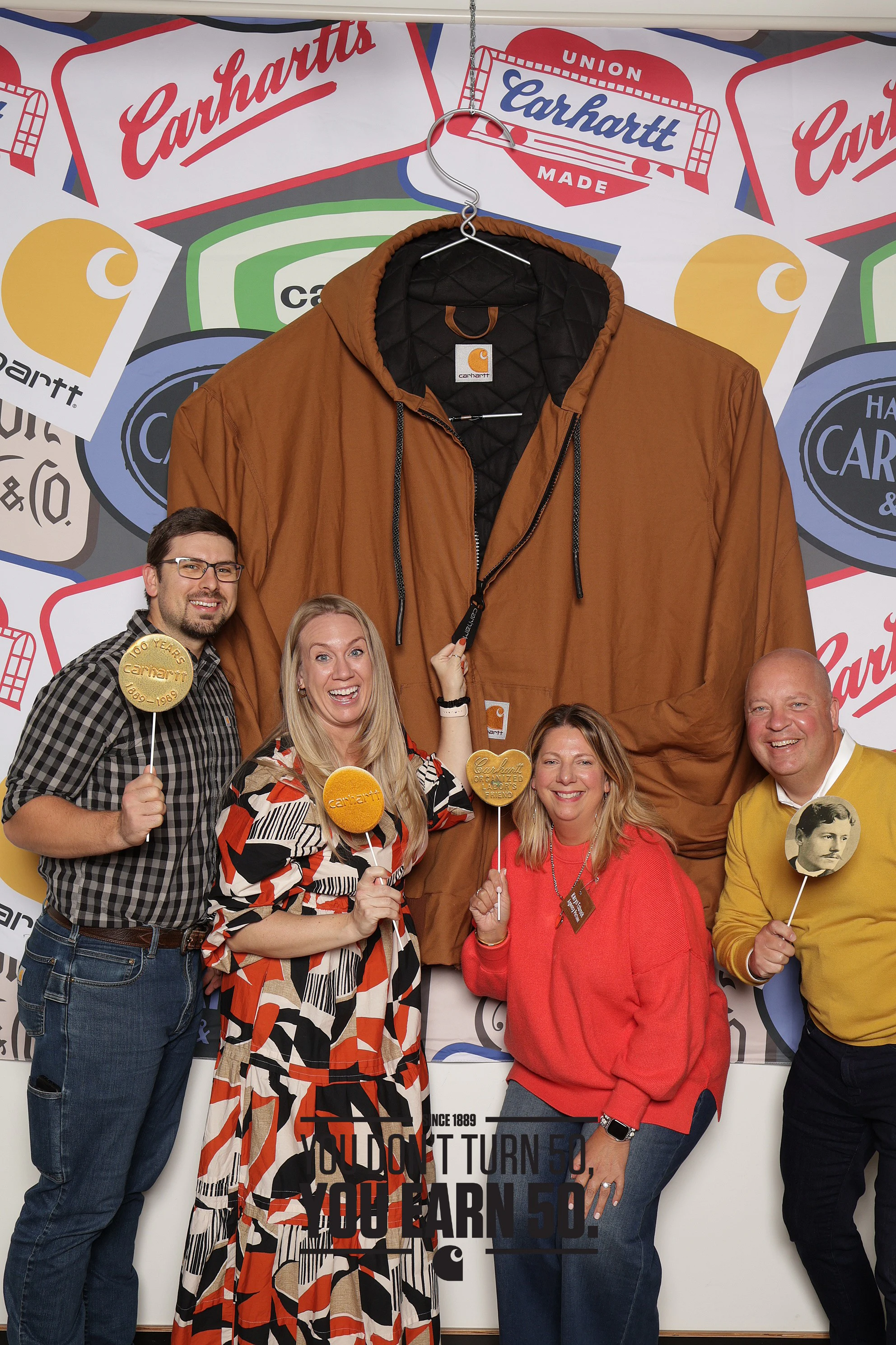 Four coworkers with props at the Carhartt Sales Meeting Welcome Party