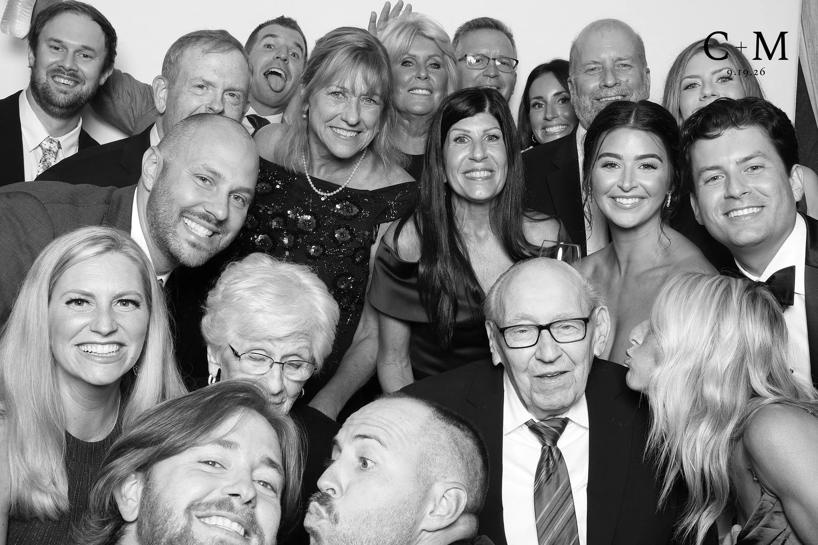 The whole family packed in, grandparents in front, everyone laughing at Carly + Mario’s wedding