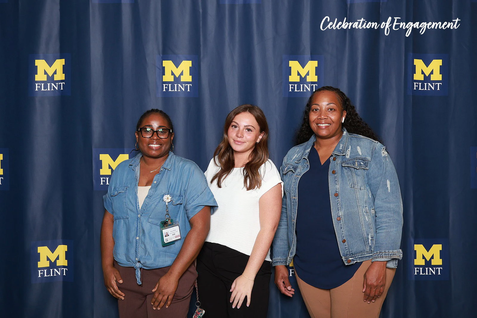 Three women standing close, two in denim jackets at Celebration of Engagement