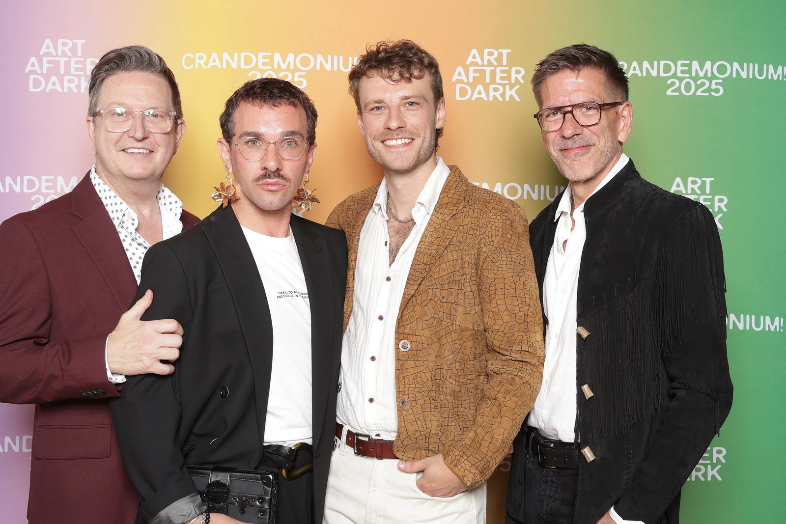 The four men smiling, arms around each other at Crandemonium 2025