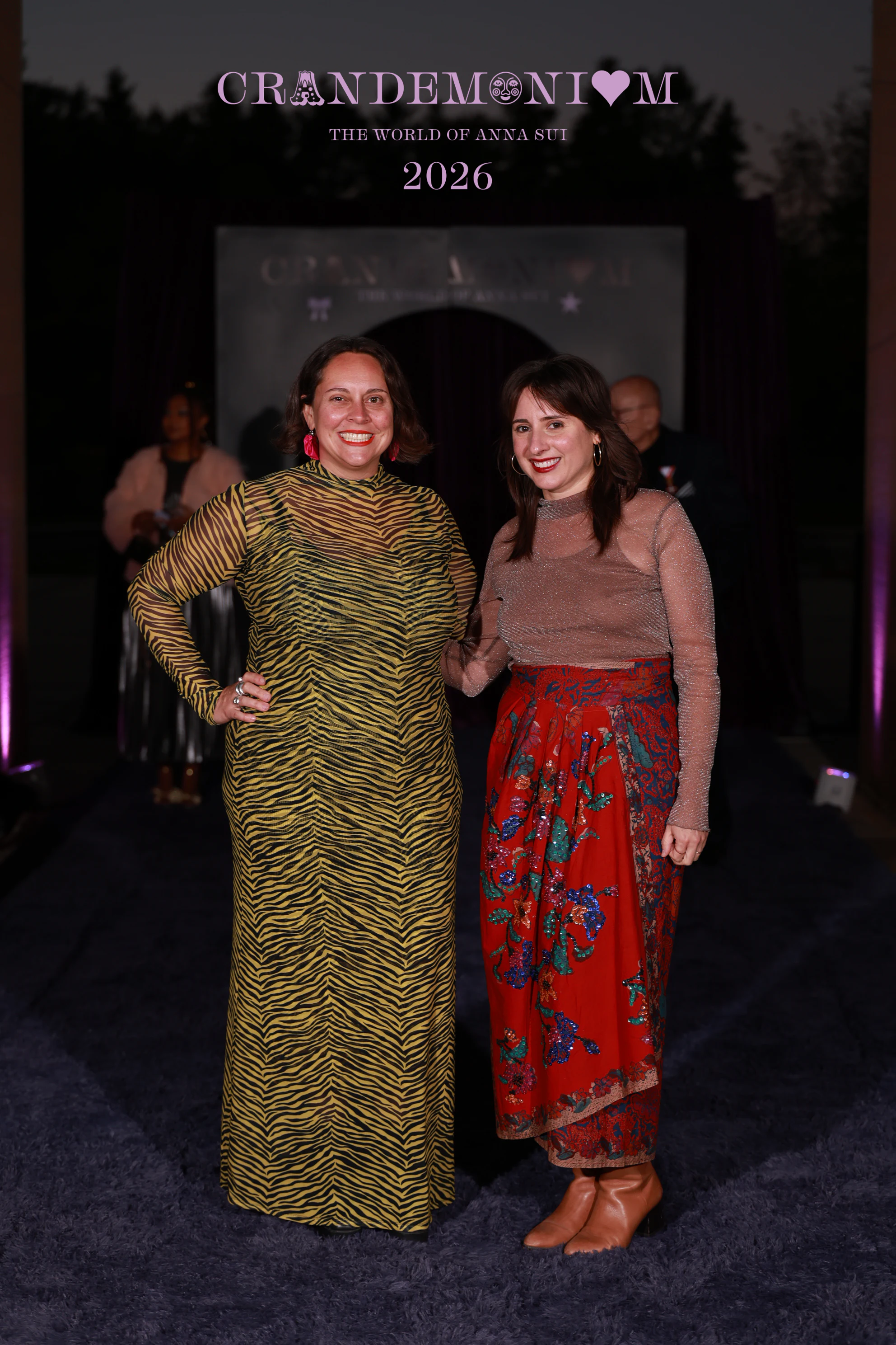 The two women in patterned dresses standing close together at Crandemonium 2026