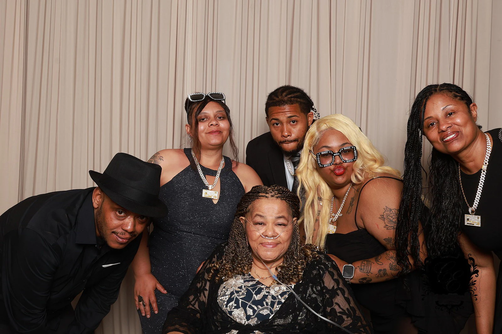 Five family members leaning in around an older woman seated in front at Cristy + Erwin