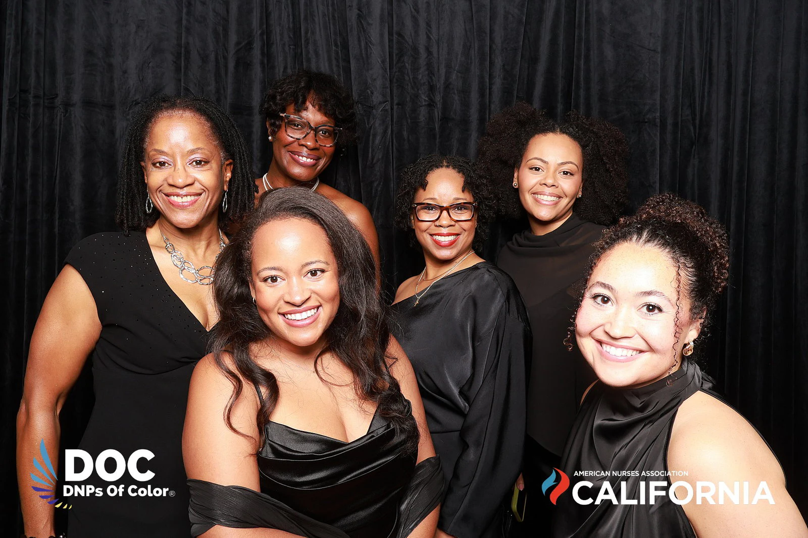 The seven women leaning in close, all smiling at DNPs of Color