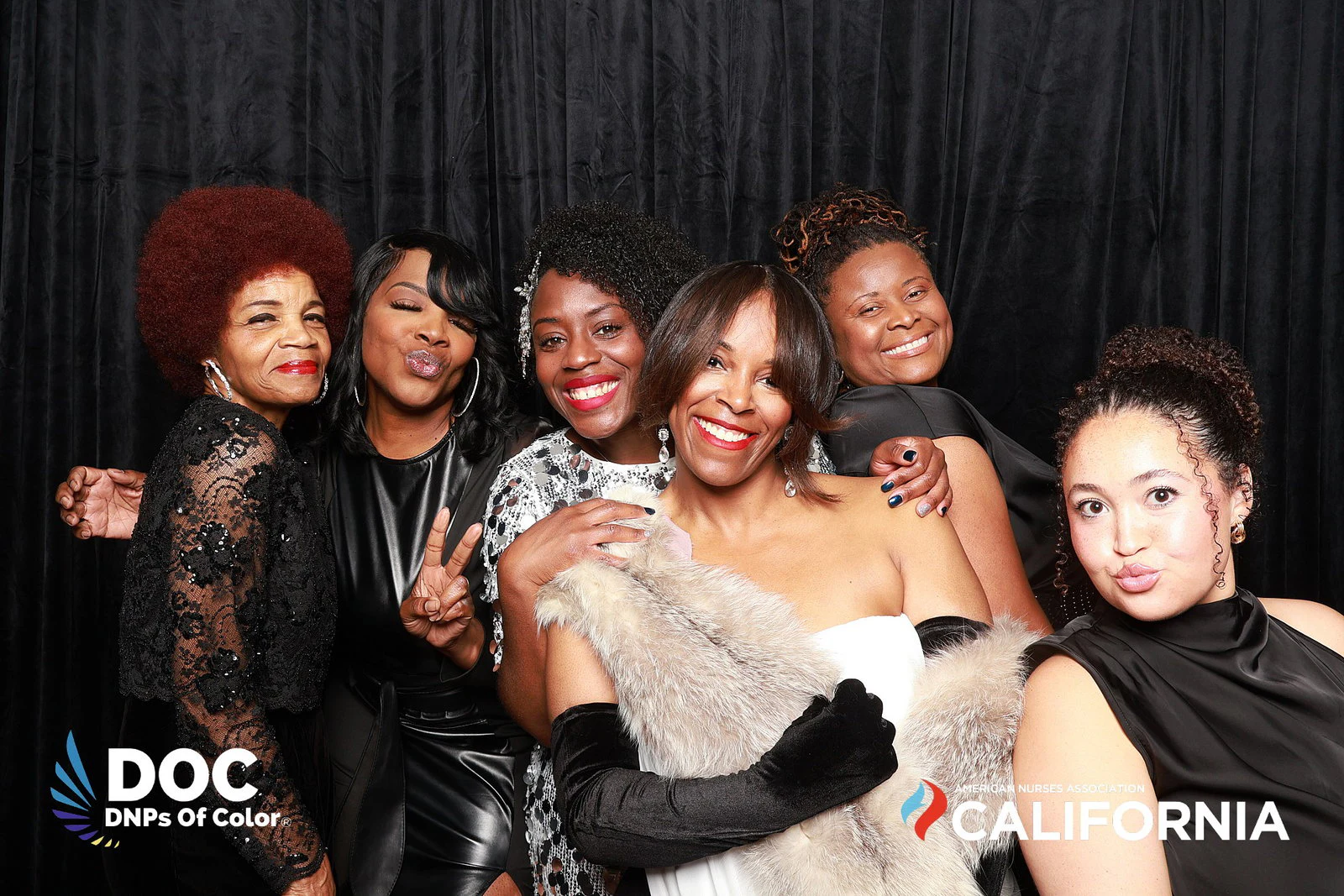 The seven women laughing, one holding up a peace sign at DNPs of Color