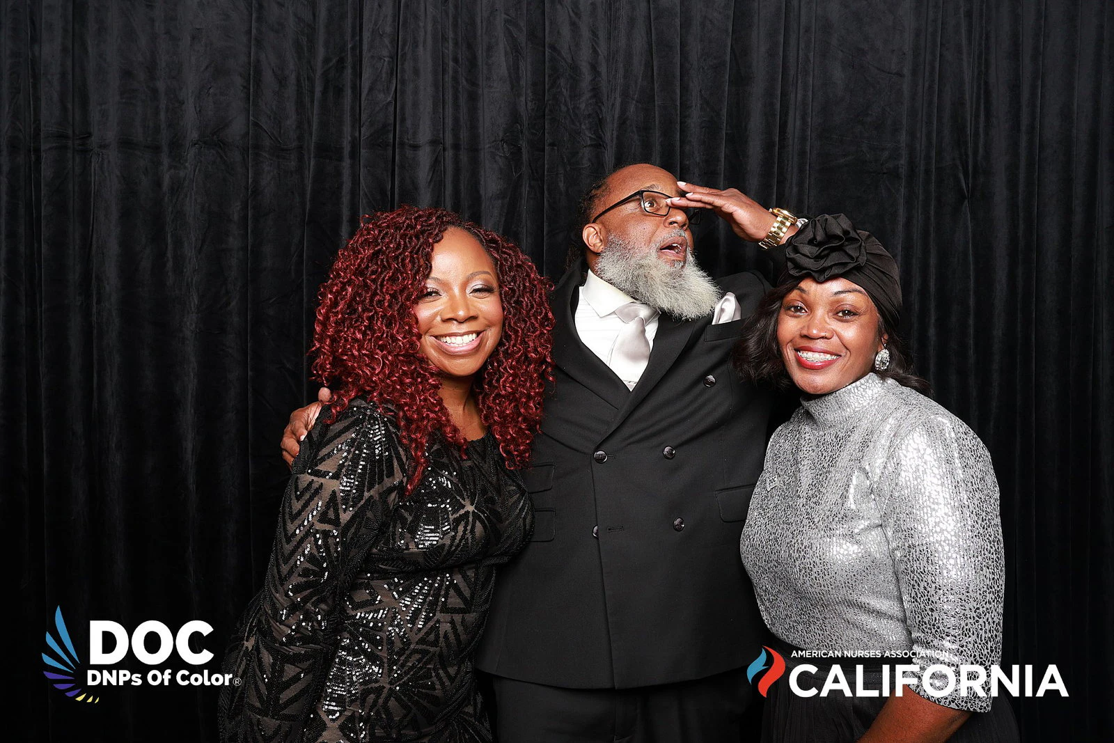 The man with a hand over his eyes while the two women smile at DNPs of Color