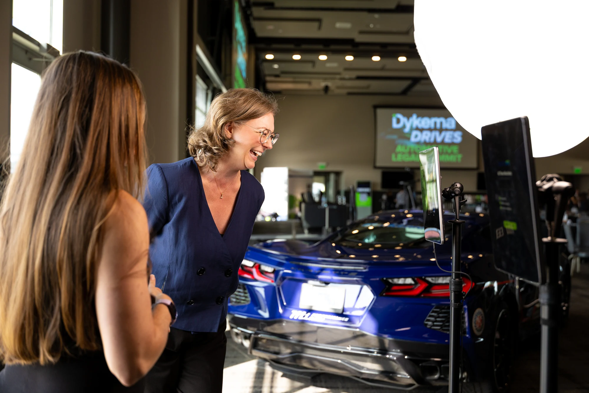 Two guests talking at the booth at Dykema Automotive Legal Summit 2026