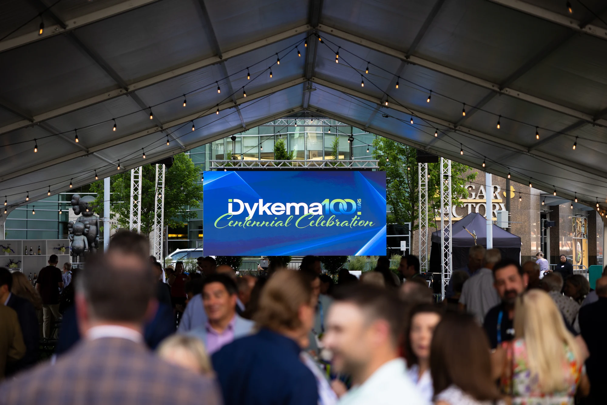 The tent under the Dykema Centennial Celebration banner at Dykema Centennial Celebration
