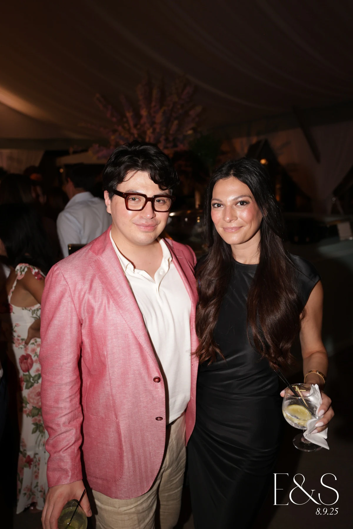 A couple with drinks under the tent, him in a pink linen blazer at Emmy + Shelby at Franklin Hills Country Club