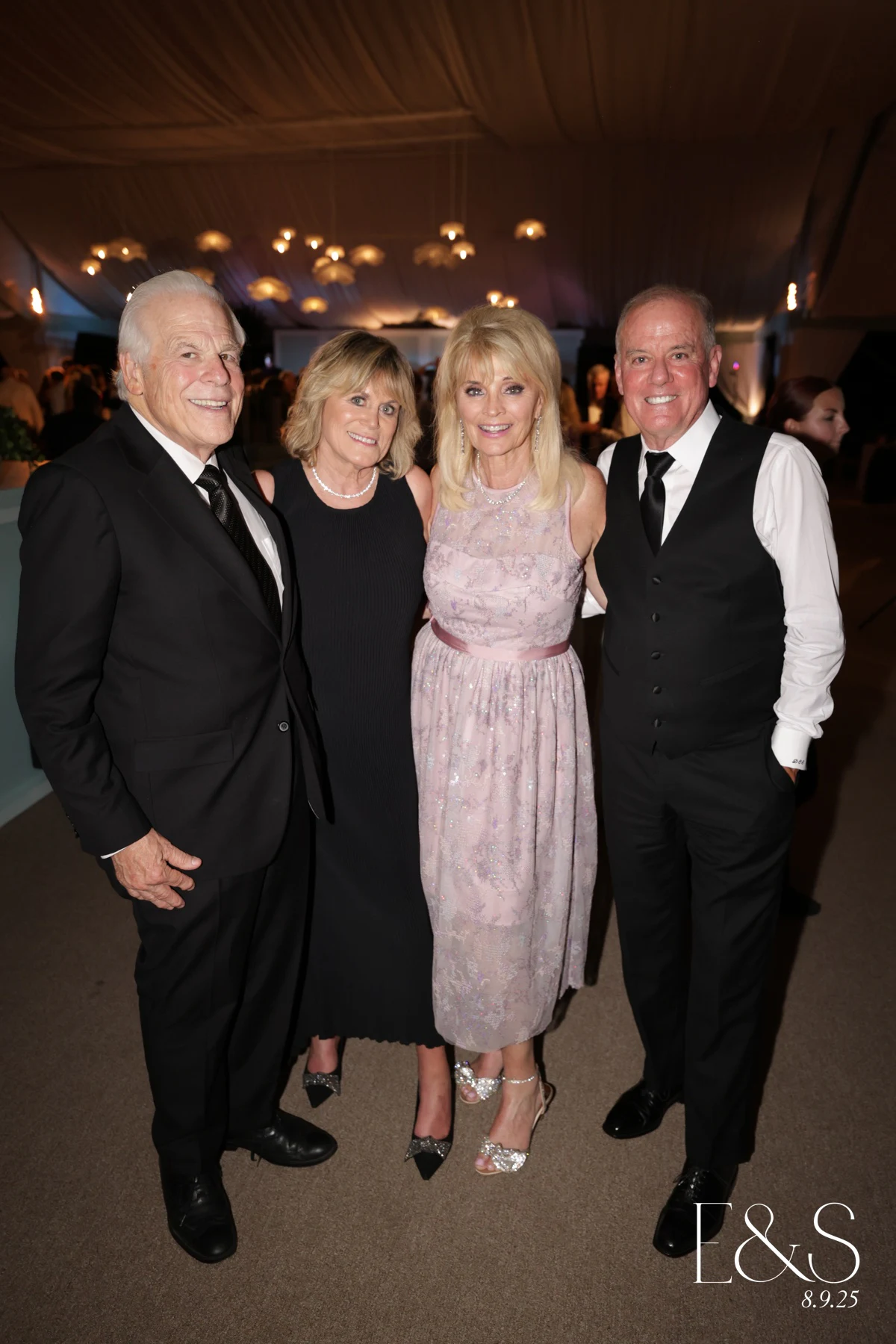 Two couples side by side, the men in tuxedos and the women in long gowns at Emmy + Shelby at Franklin Hills Country Club