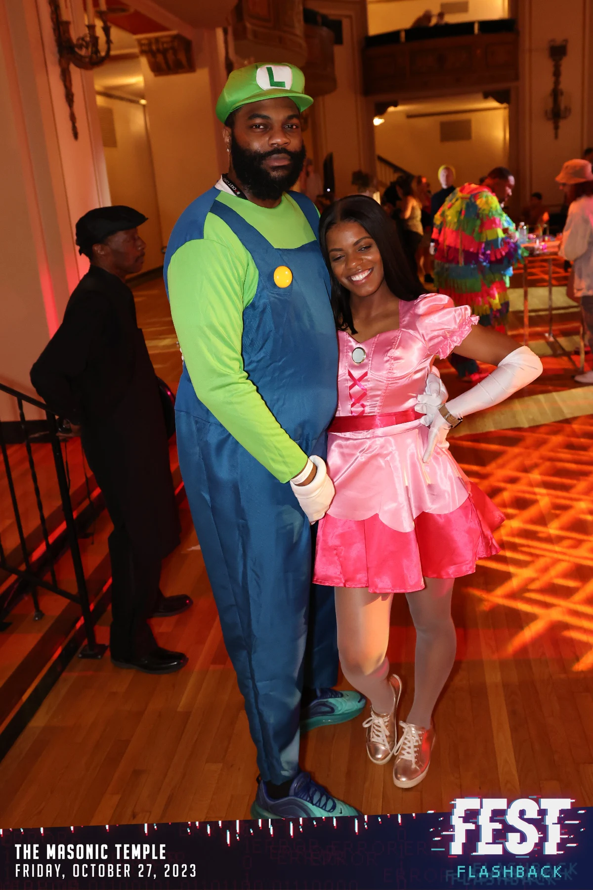 Two guests as Luigi and Princess Peach at the FEST Halloween party at the Masonic Temple