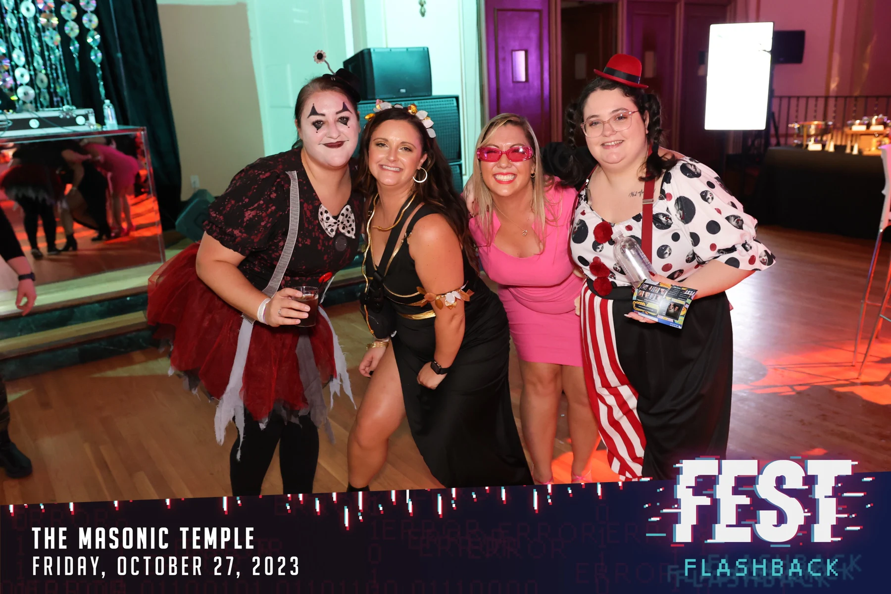 Four guests leaning in, one in mime makeup and a red tutu, the FEST Flashback graphic along the bottom, at FEST Halloween Party at the Masonic Temple