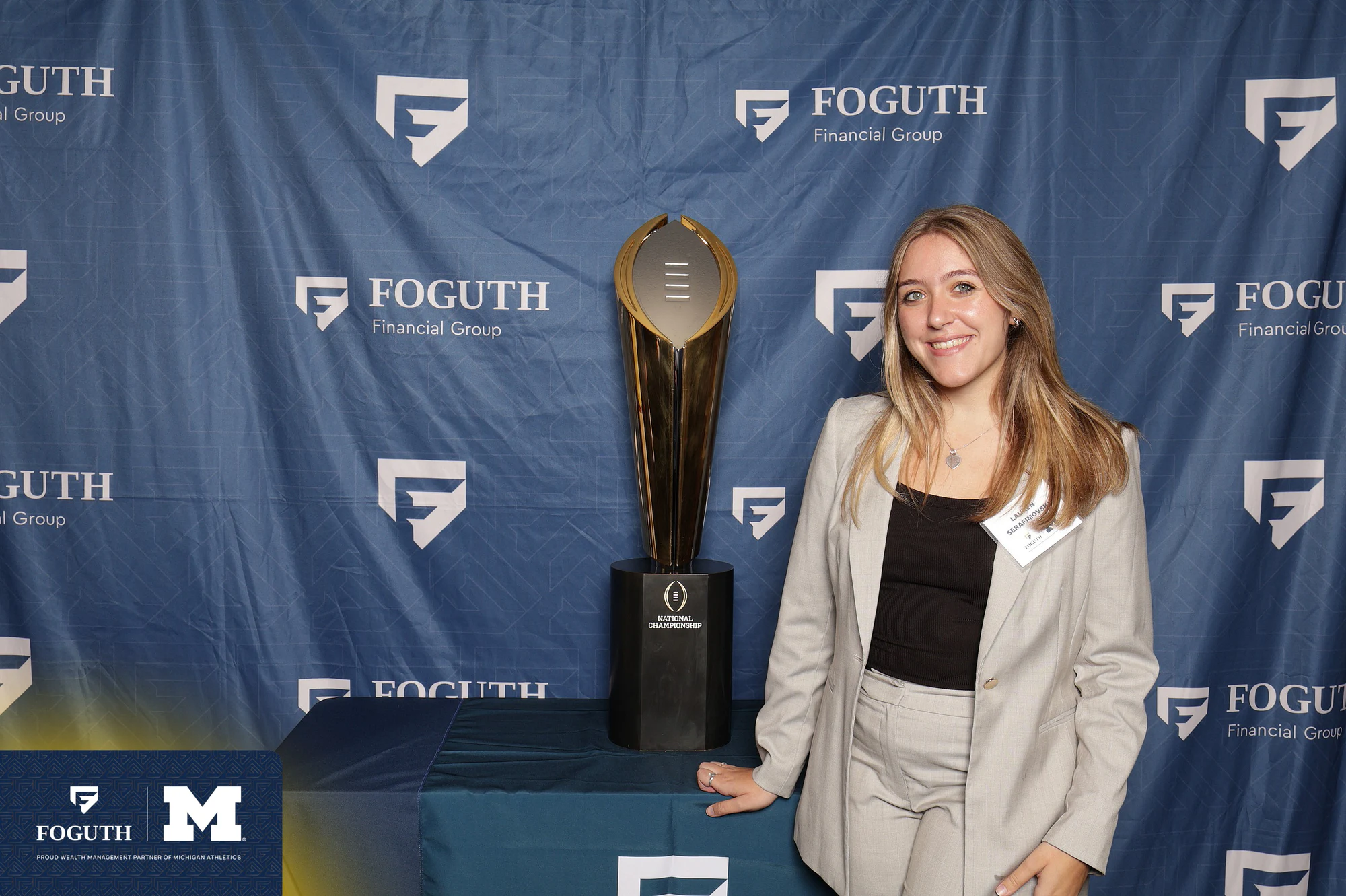 Solo portrait with the trophy at Foguth Financial at The Big House
