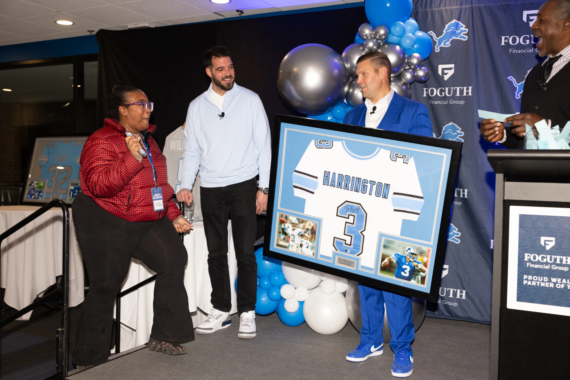 Group at the screen with the prize at Foguth Financial at Ford Field