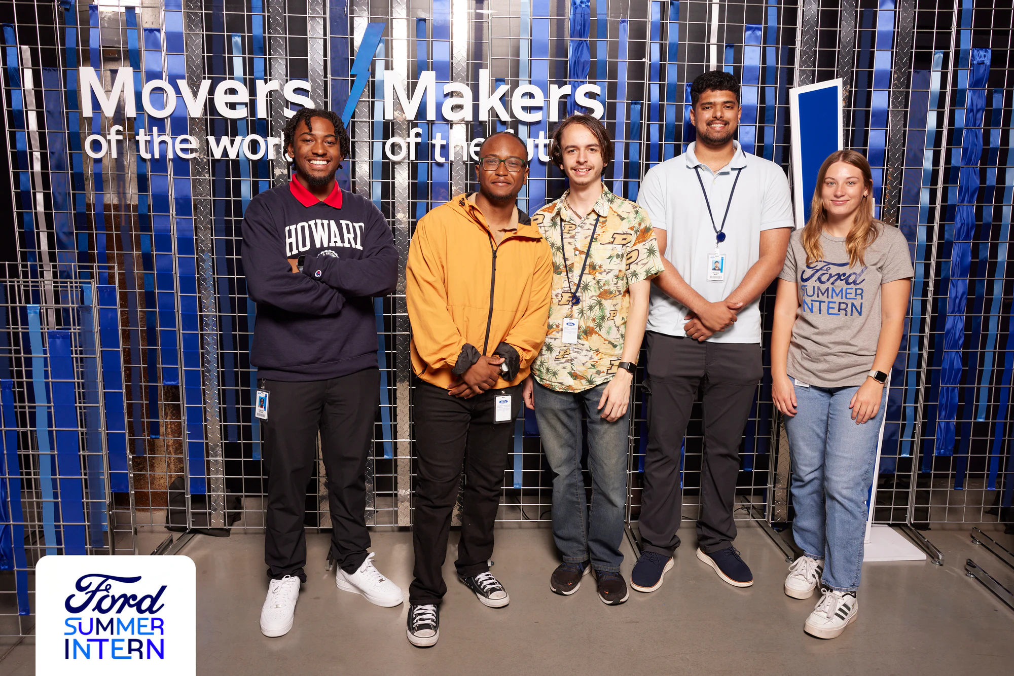 Five interns in a row, two in a Howard sweatshirt and a yellow jacket at the Ford Summer Intern Mixer 2024