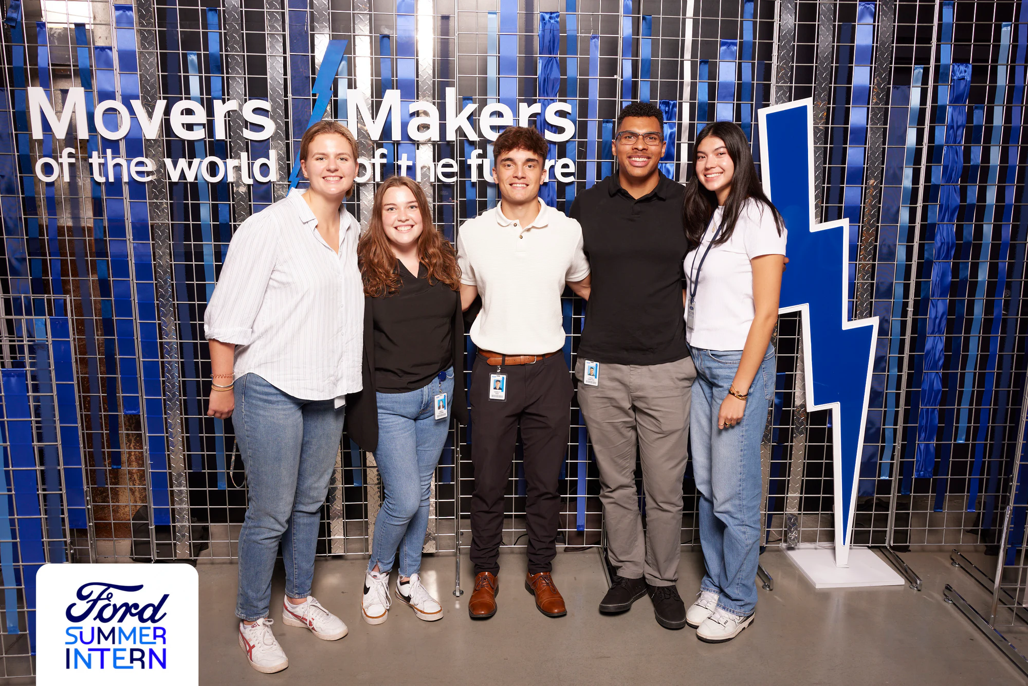 Five interns in white and black in front of the blue wall at the Ford Summer Intern Mixer 2024