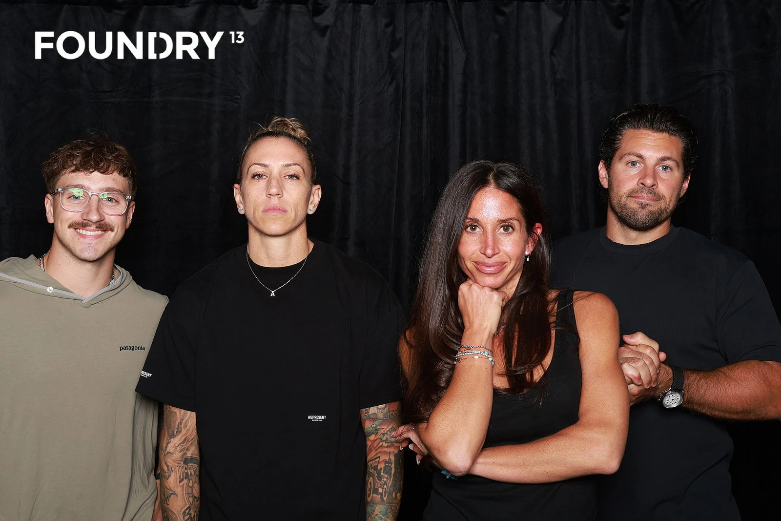 Four friends standing together at Foundry 13