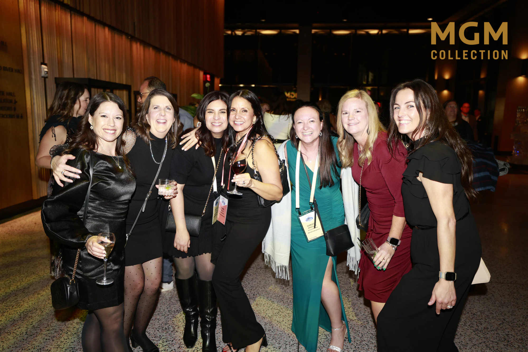 Seven women, arms around each other, the MGM Collection logo in the corner, at Fuel Our Future Gala