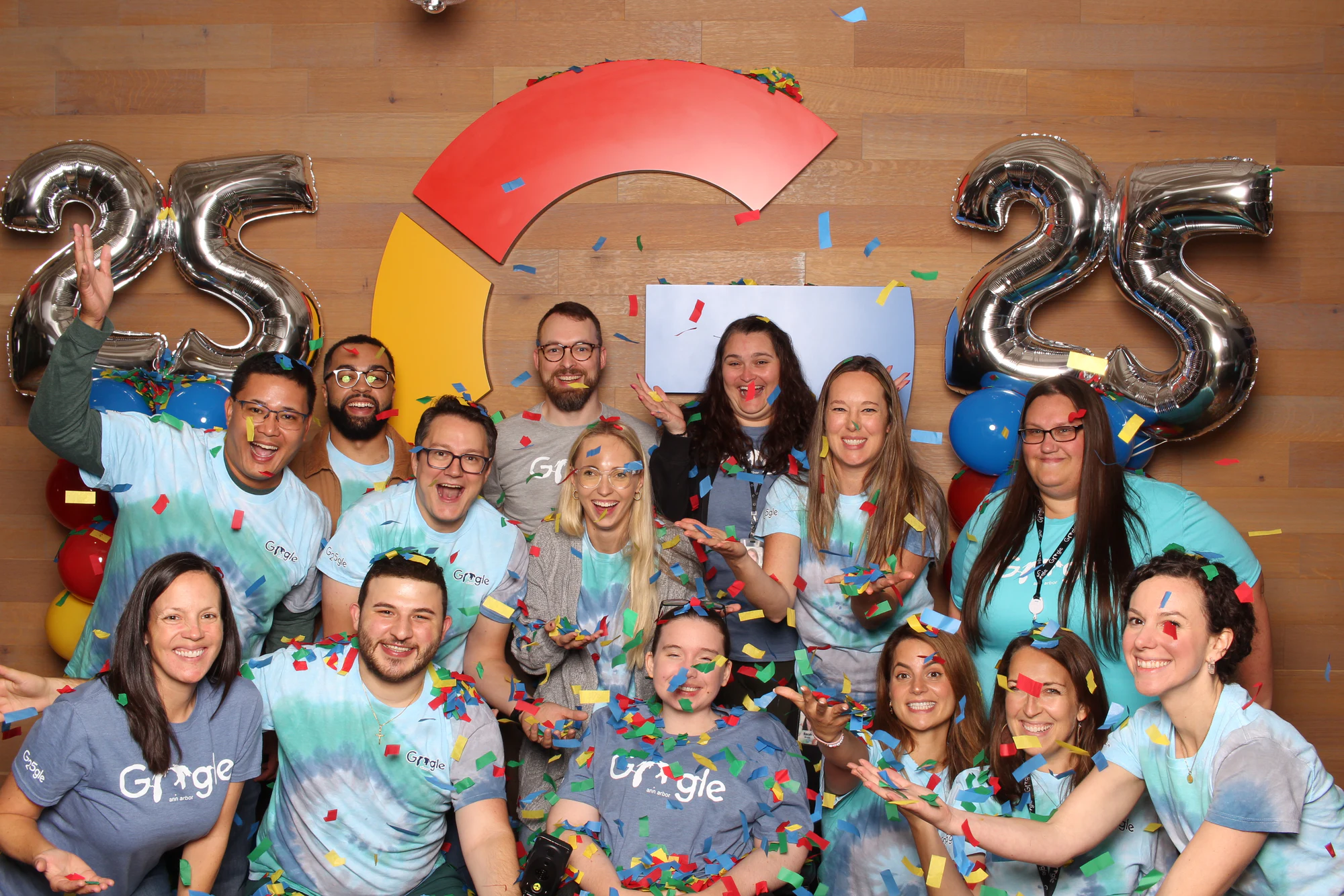 The team again with confetti in the air and hands up at Google’s 25th Birthday
