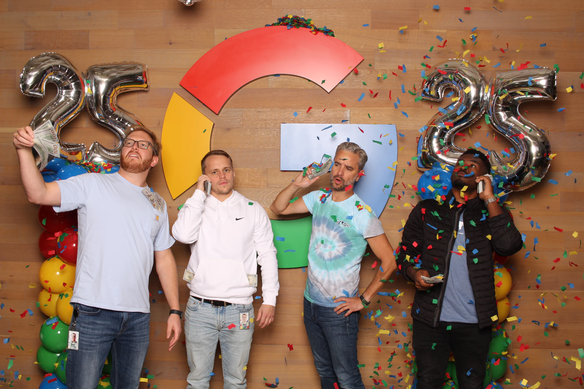 The four men mid-throw, paper and confetti falling around them at Google’s 25th Birthday