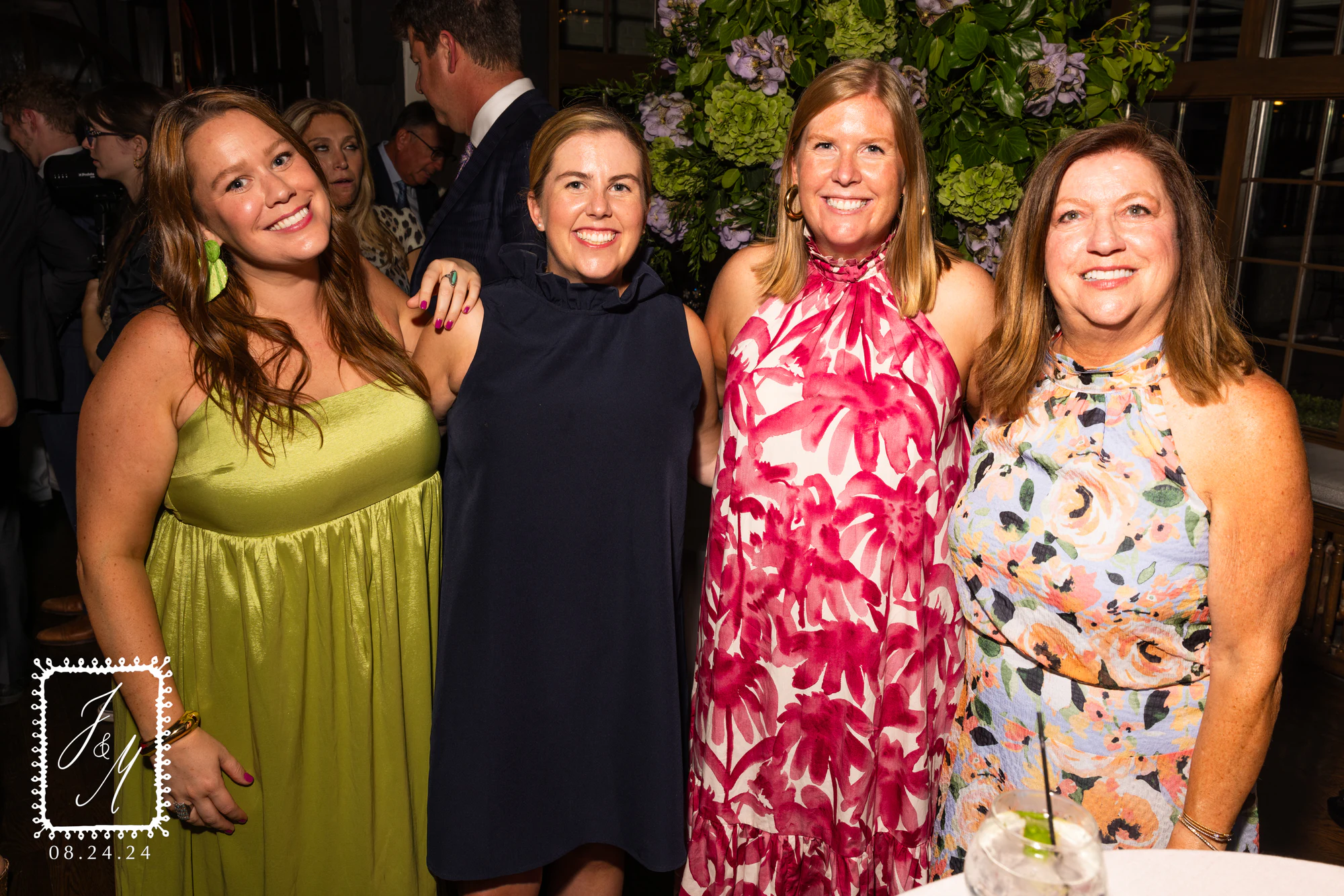 Four guests in bright dresses in front of the hydrangeas at Jaclyn + Michael at Franklin Hills Country Club
