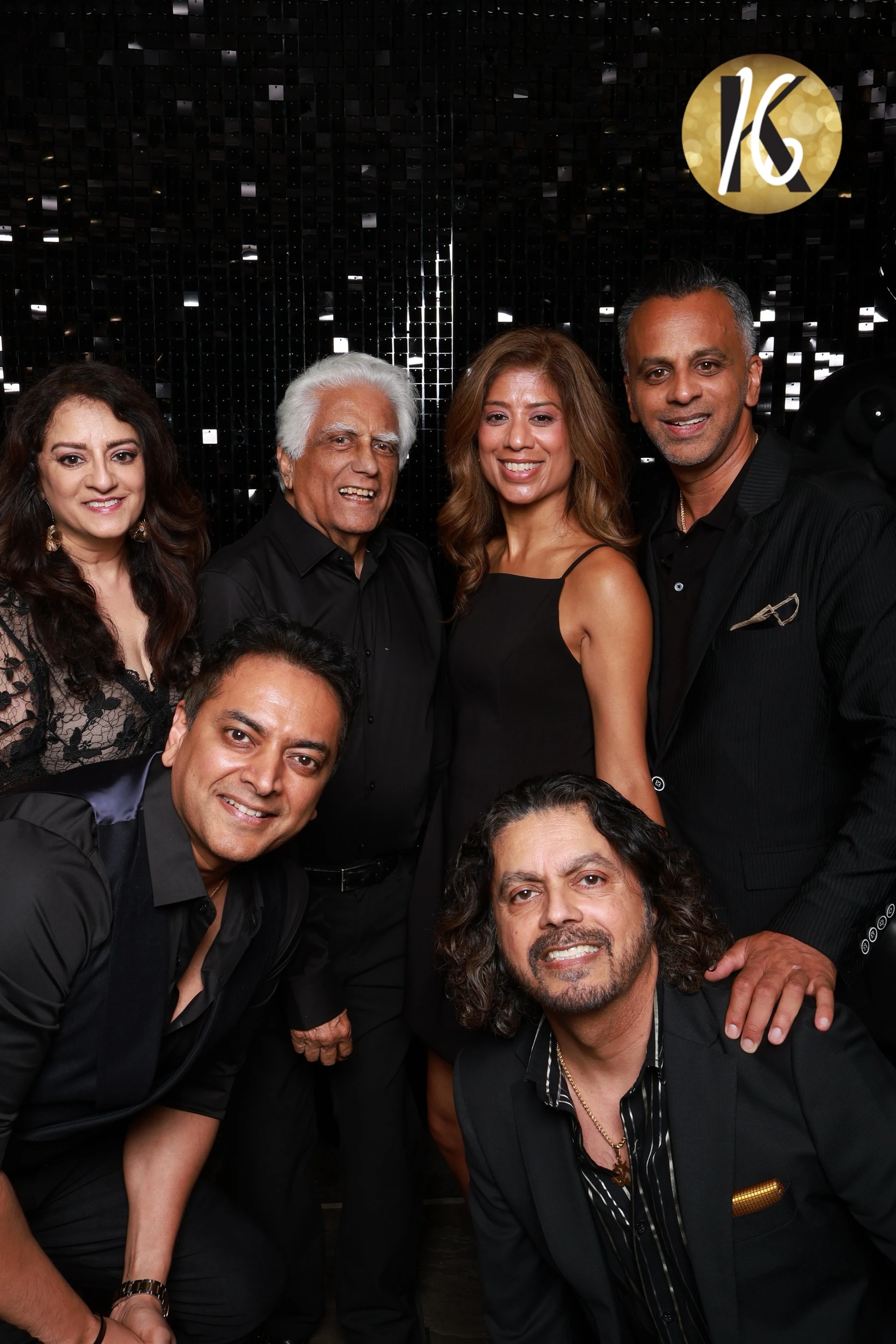 A family group stacked in two rows, the men grinning in front, at Karishma’s Sweet 16