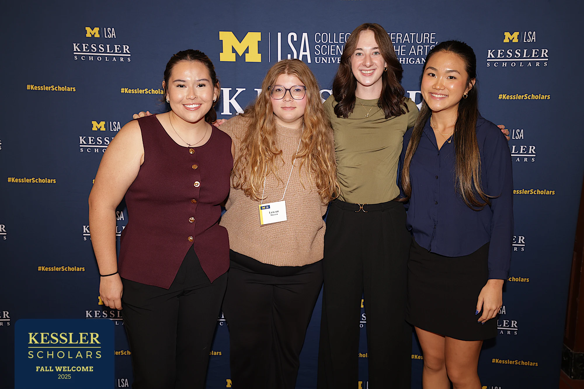 Four together at the wall at Kessler Scholars Welcome Dinner