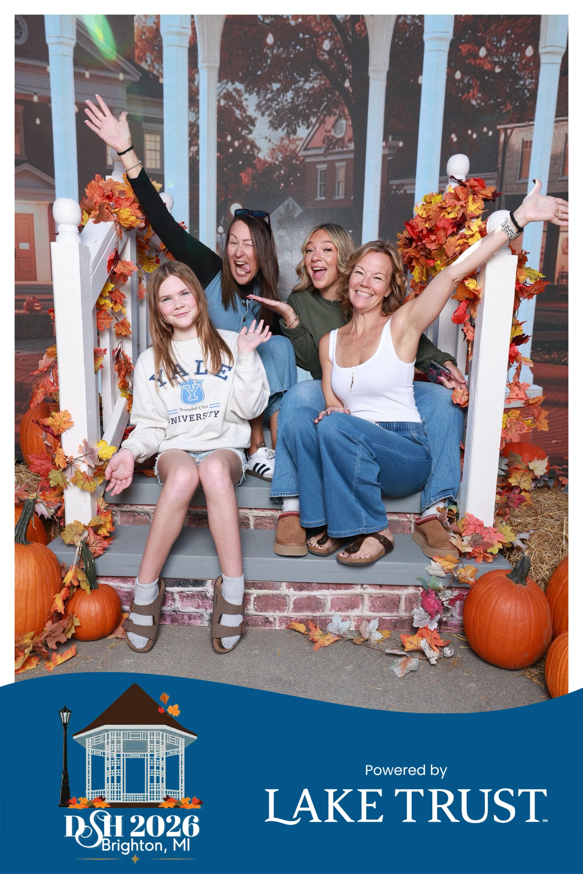 Four guests on the porch steps with their arms thrown wide at Destination Starz Hollow
