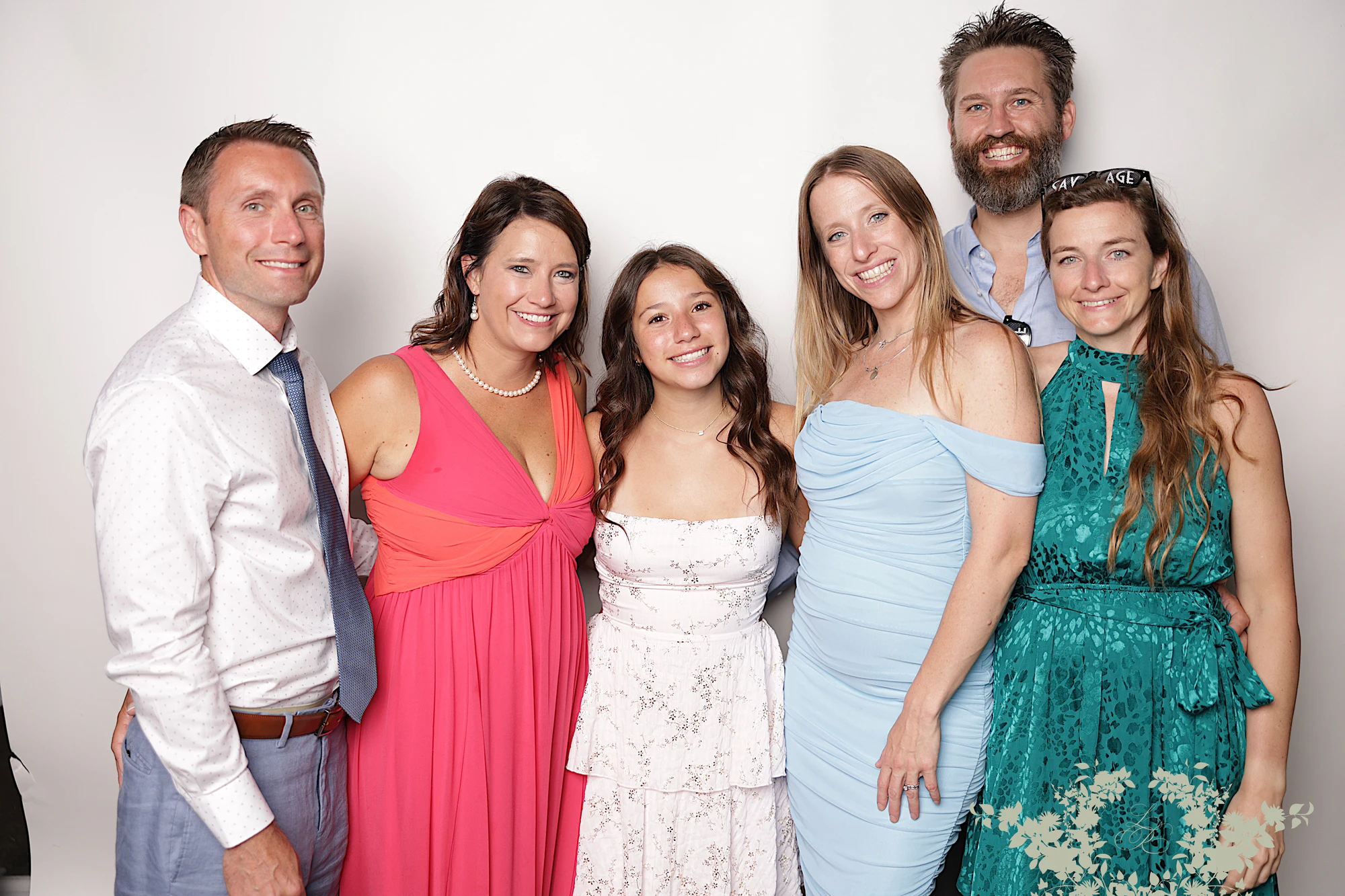 Six guests in summer colors pressed together in one frame at Lindsay + Ryan