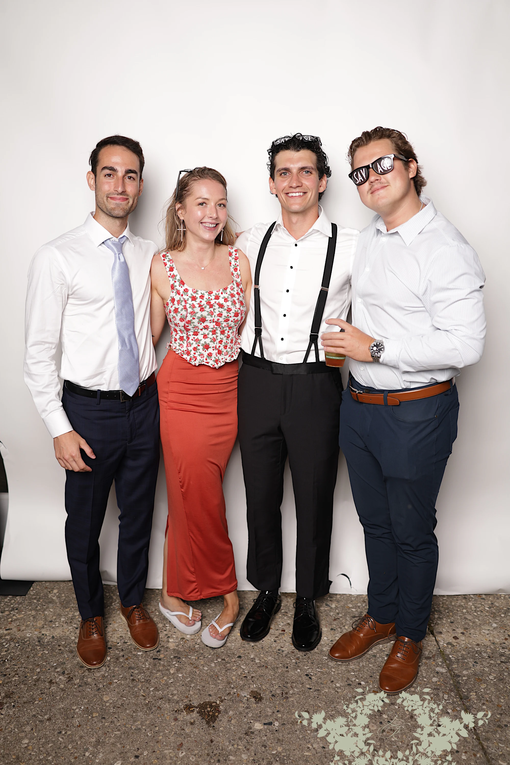 Four guests arm in arm, one in novelty sunglasses at Lindsay + Ryan