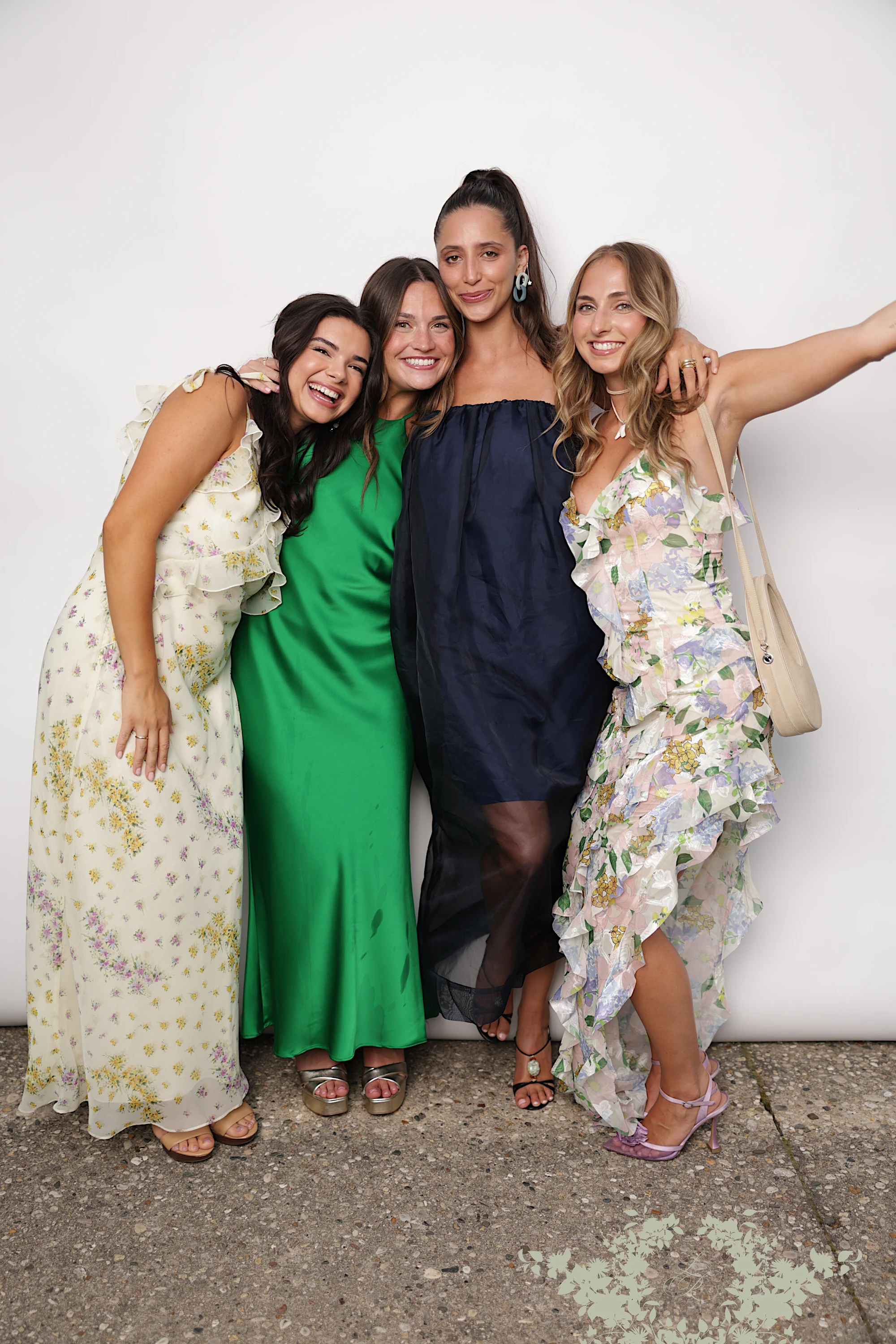 Four women in a row, one throwing a peace sign at Lindsay + Ryan