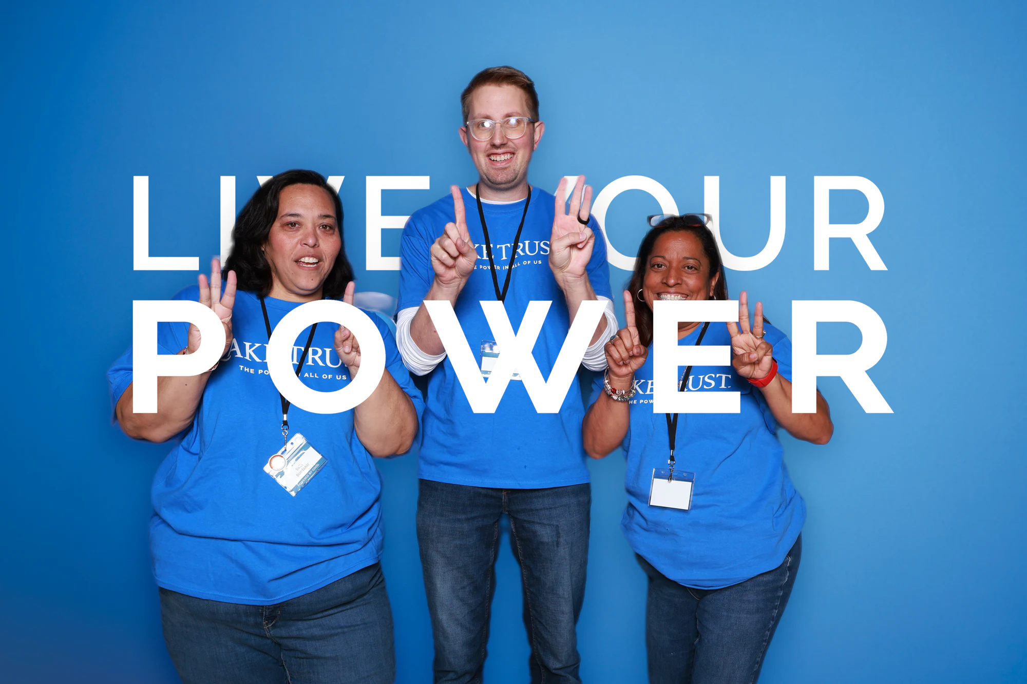 The three guests holding up peace signs at Live Your Power