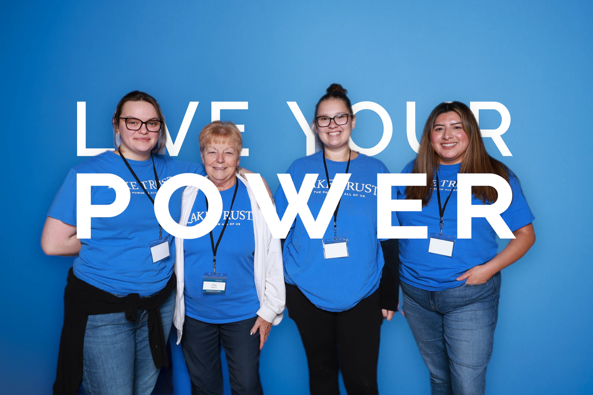 Four women in Lake Trust shirts standing in a row at Live Your Power