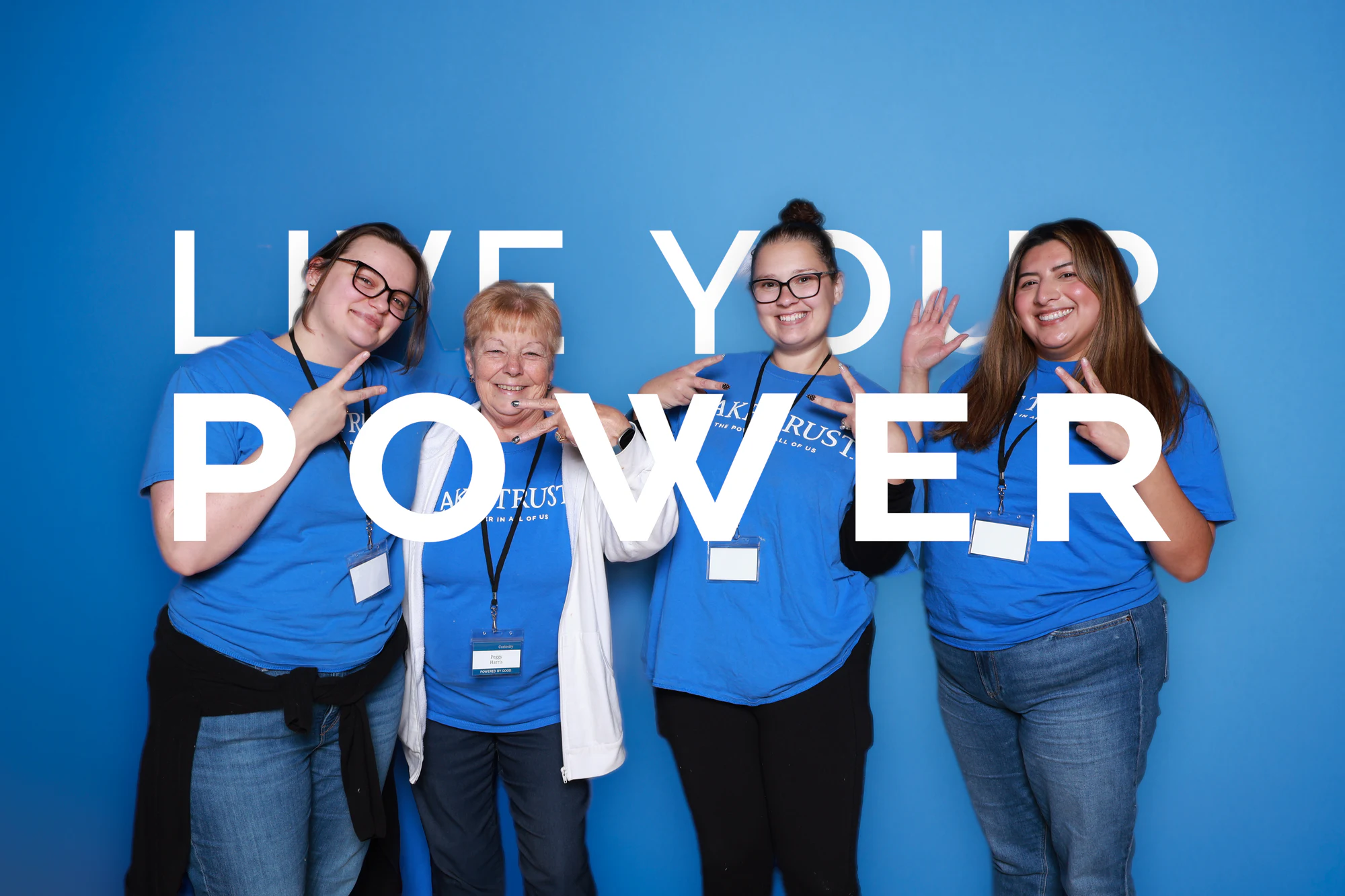 The four women flashing peace signs at Live Your Power