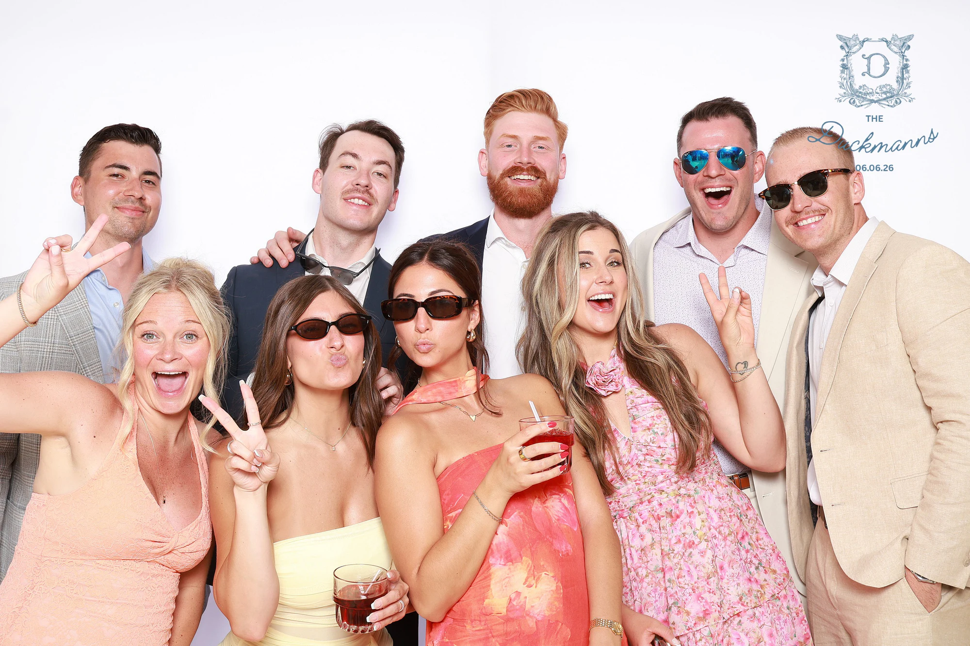 Nine friends crowded together, the women in front throwing peace signs and the men behind in sunglasses at Melissa + Crosley
