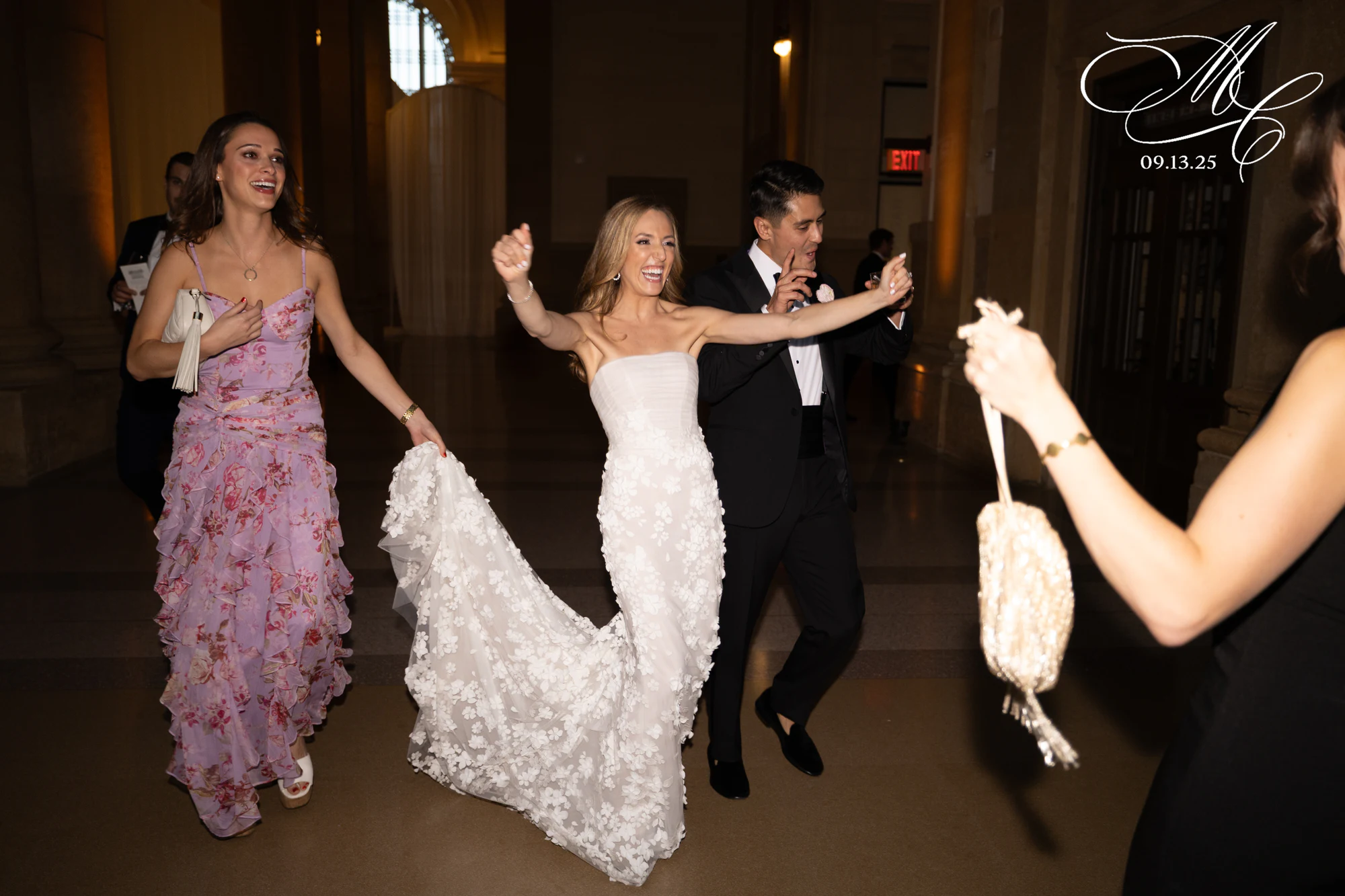 Bride mid-dance holding her dress up, laughing at Madison + Charlie at Michigan Central