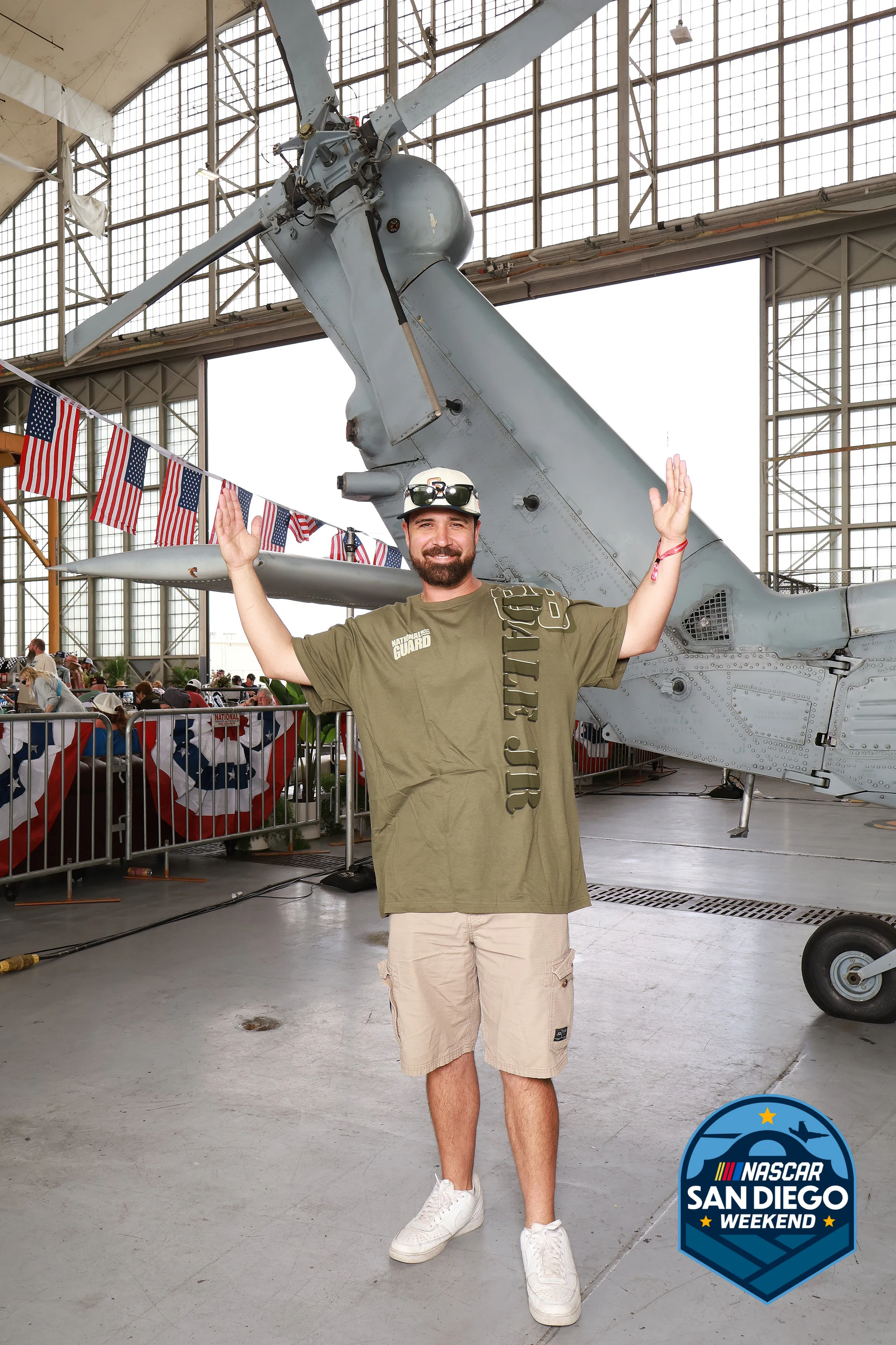 A guest throwing double peace signs at NASCAR San Diego