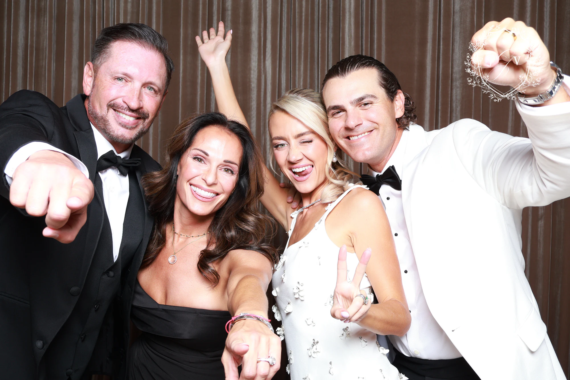 The two couples cheering with fists and hands in the air at Nash Gaurino Wedding