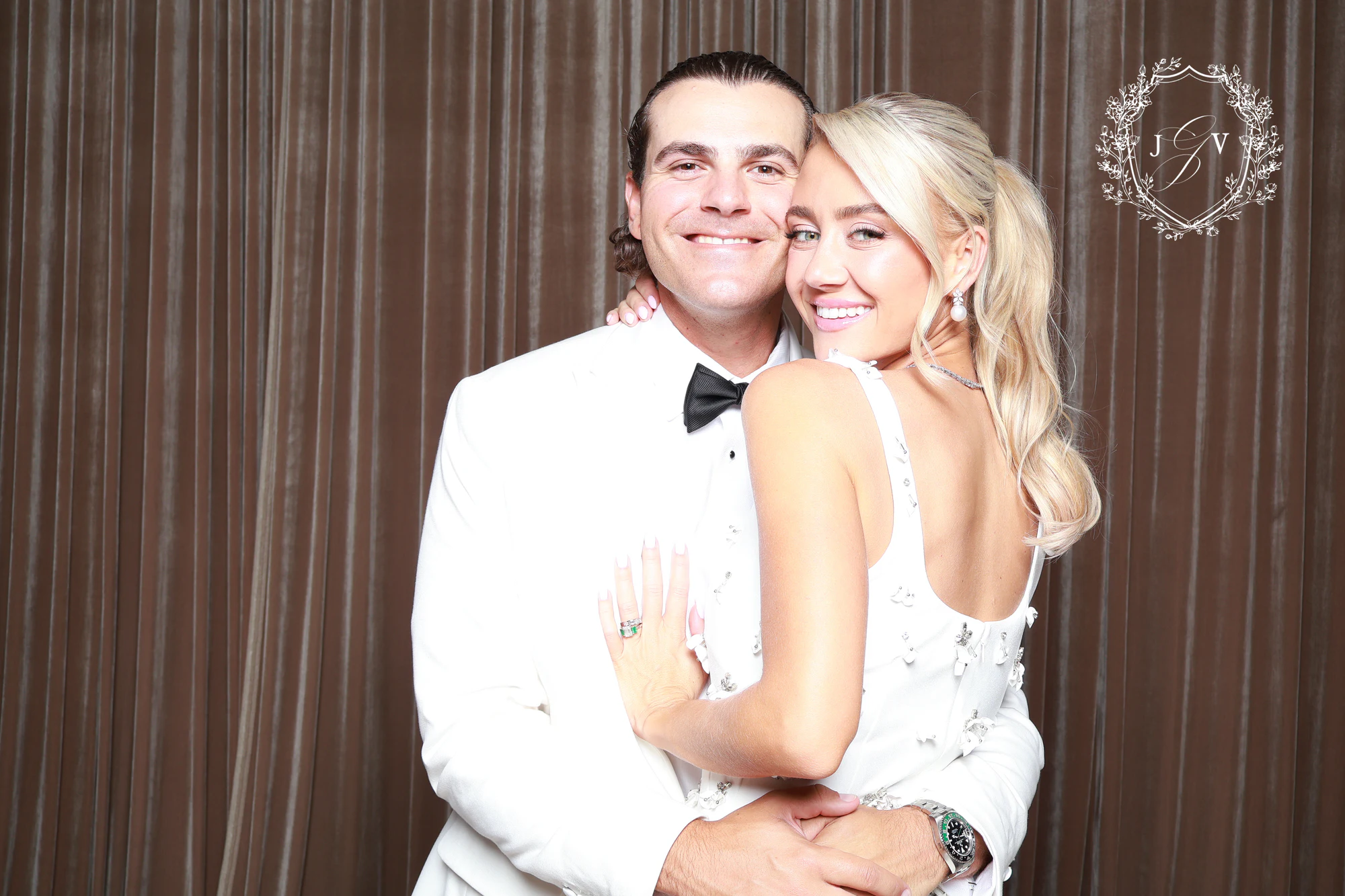 The bride and groom hugging, him in a white dinner jacket, at Nash Gaurino Wedding