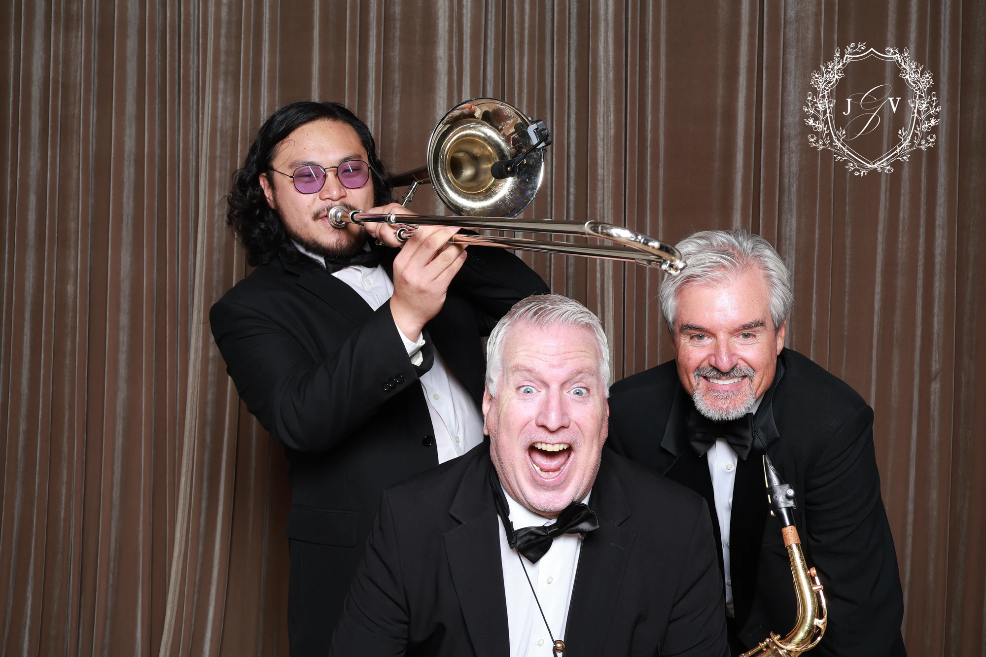 The trombone player leaning in over the others, the saxophonist grinning below at Nash Gaurino Wedding