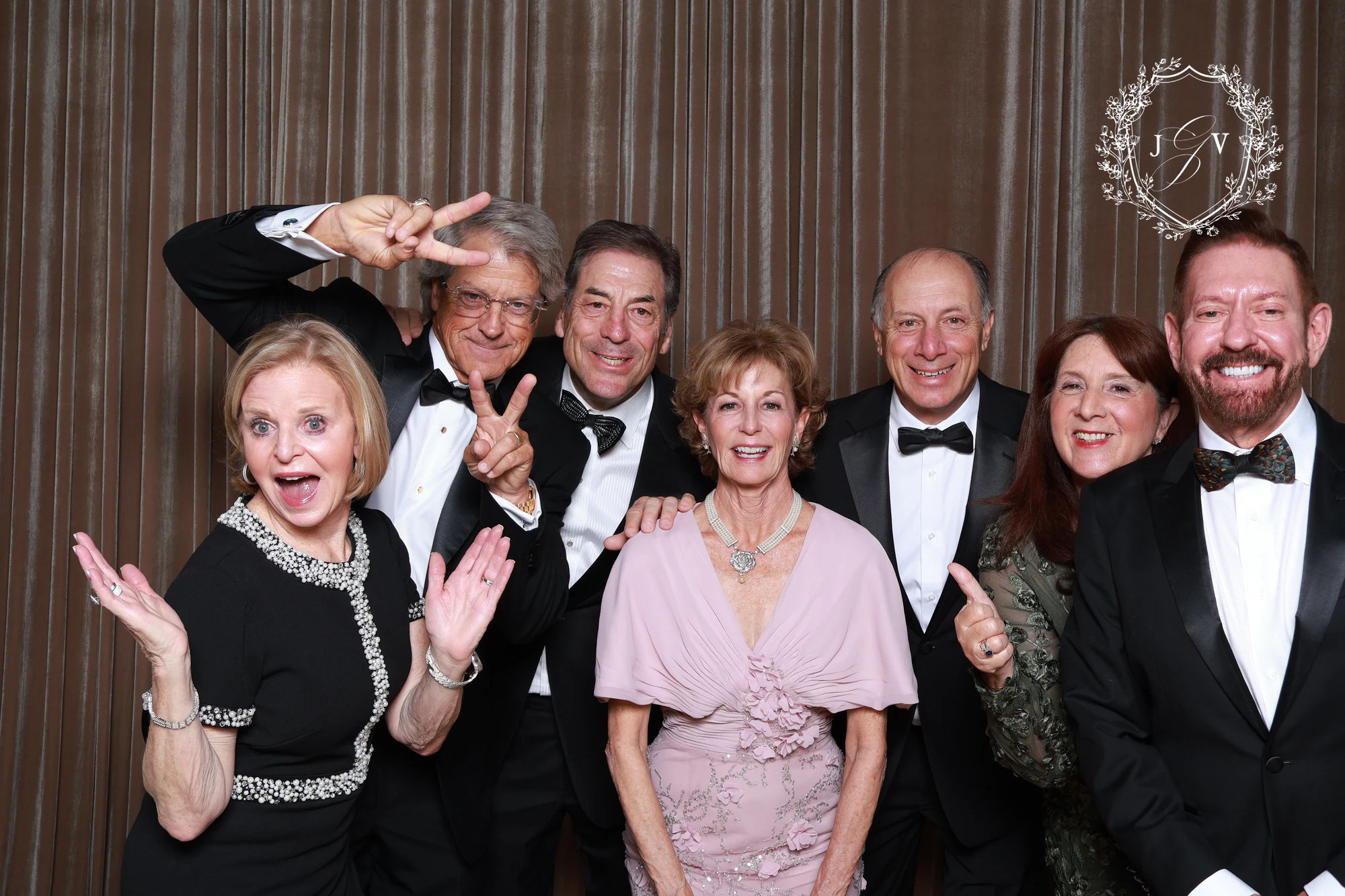The seven guests waving, one with peace signs held high at Nash Gaurino Wedding