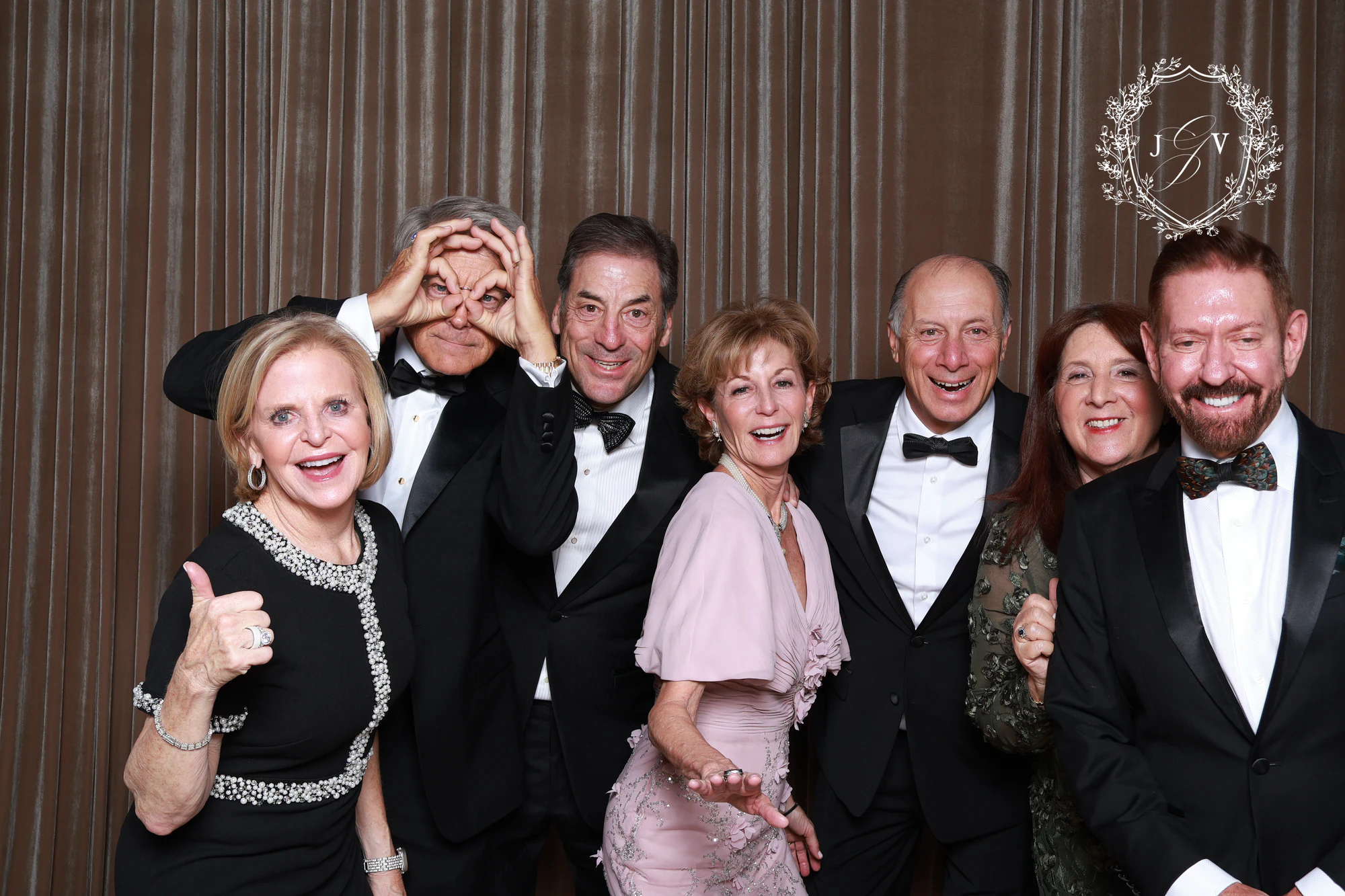 The seven guests giving thumbs up and making goggles with their hands at Nash Gaurino Wedding