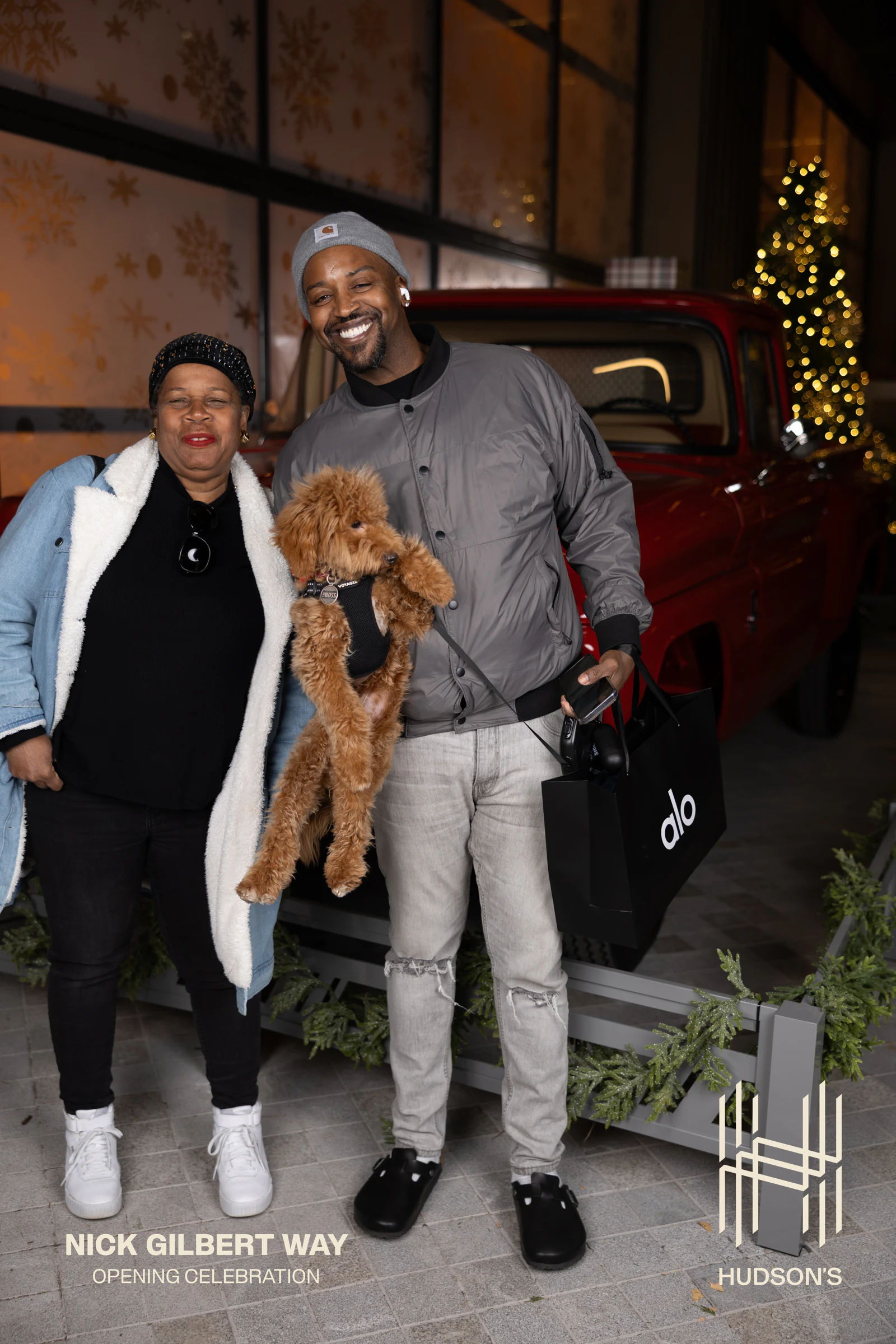 Couple holding their dog up to the camera at Nick Gilbert Way Opening Celebration