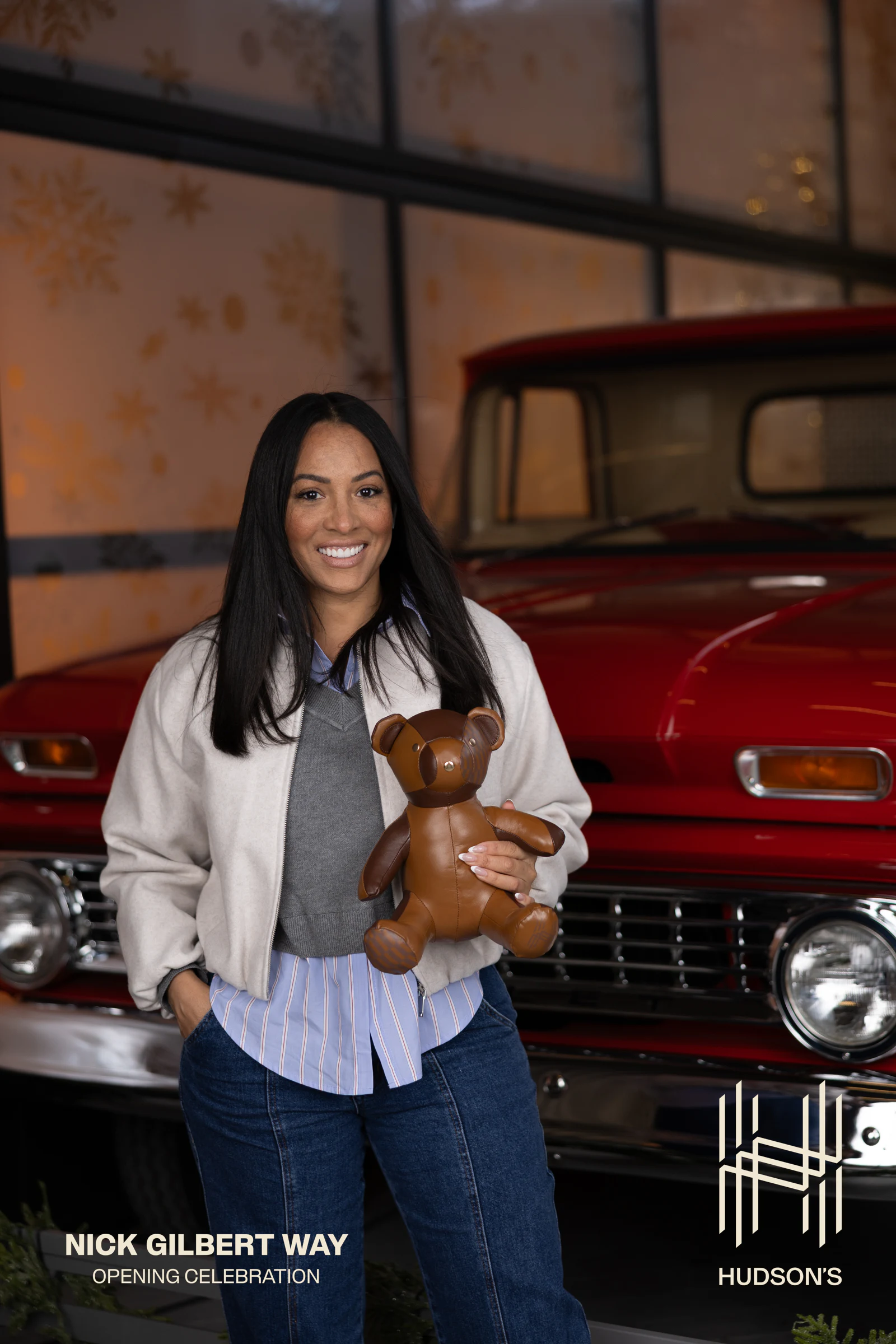 Woman holding a small teddy bear at Nick Gilbert Way Opening Celebration