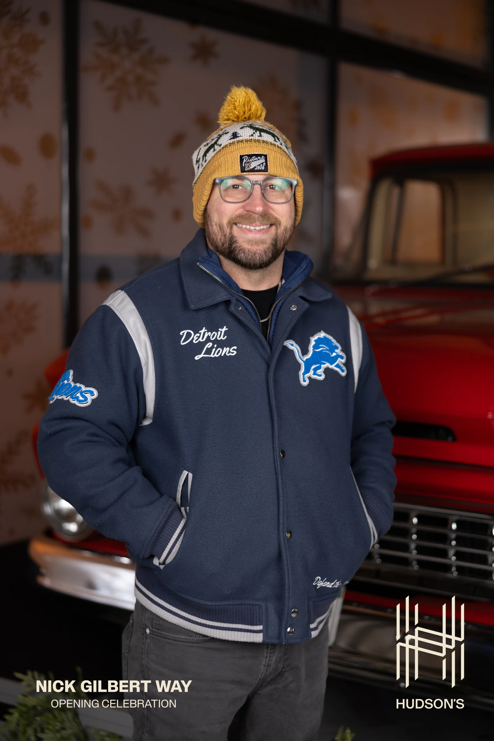 Man in the Lions jacket and knit hat, big smile at Nick Gilbert Way Opening Celebration