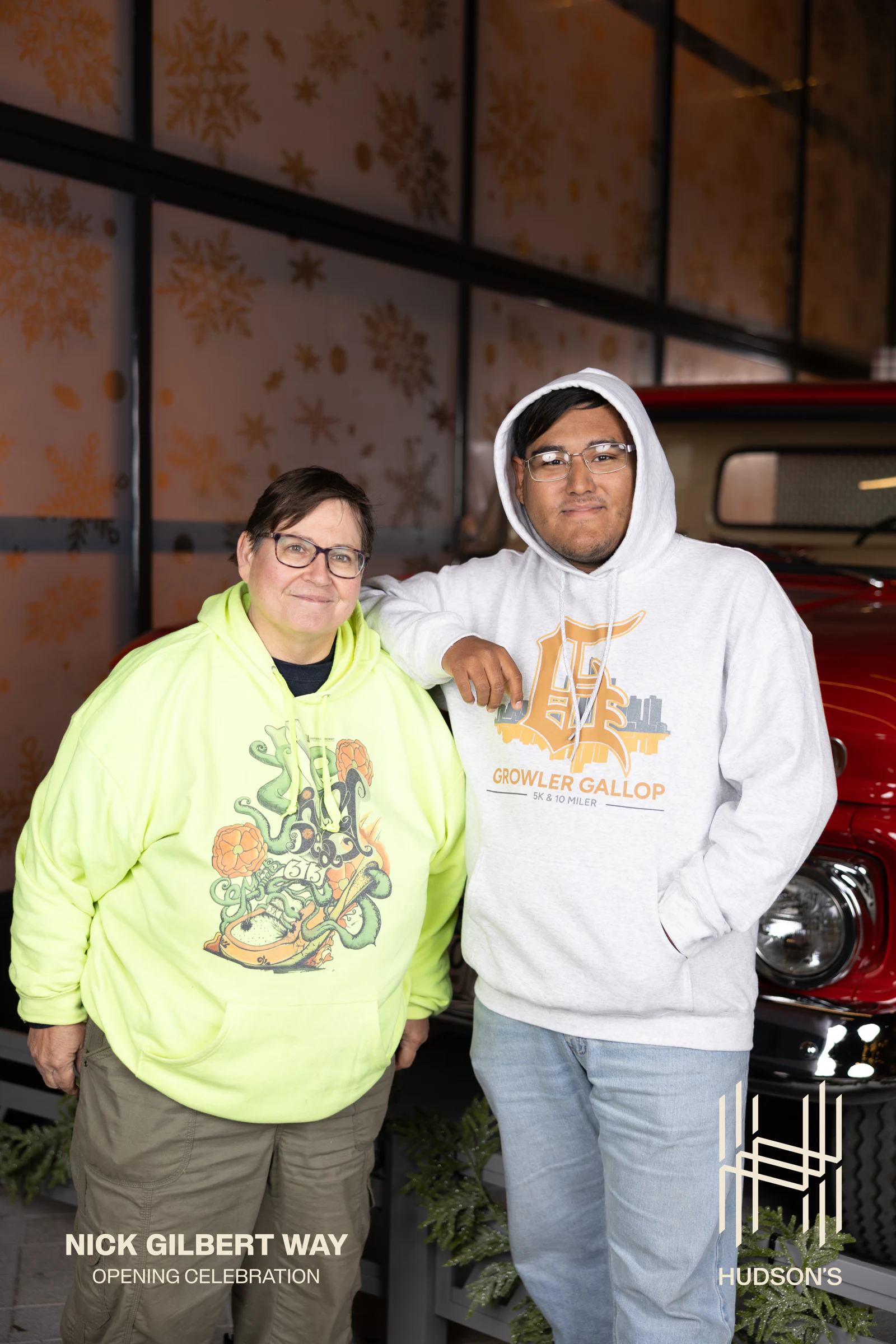 Mother and son in matching neon shirts, both relaxed at Nick Gilbert Way Opening Celebration