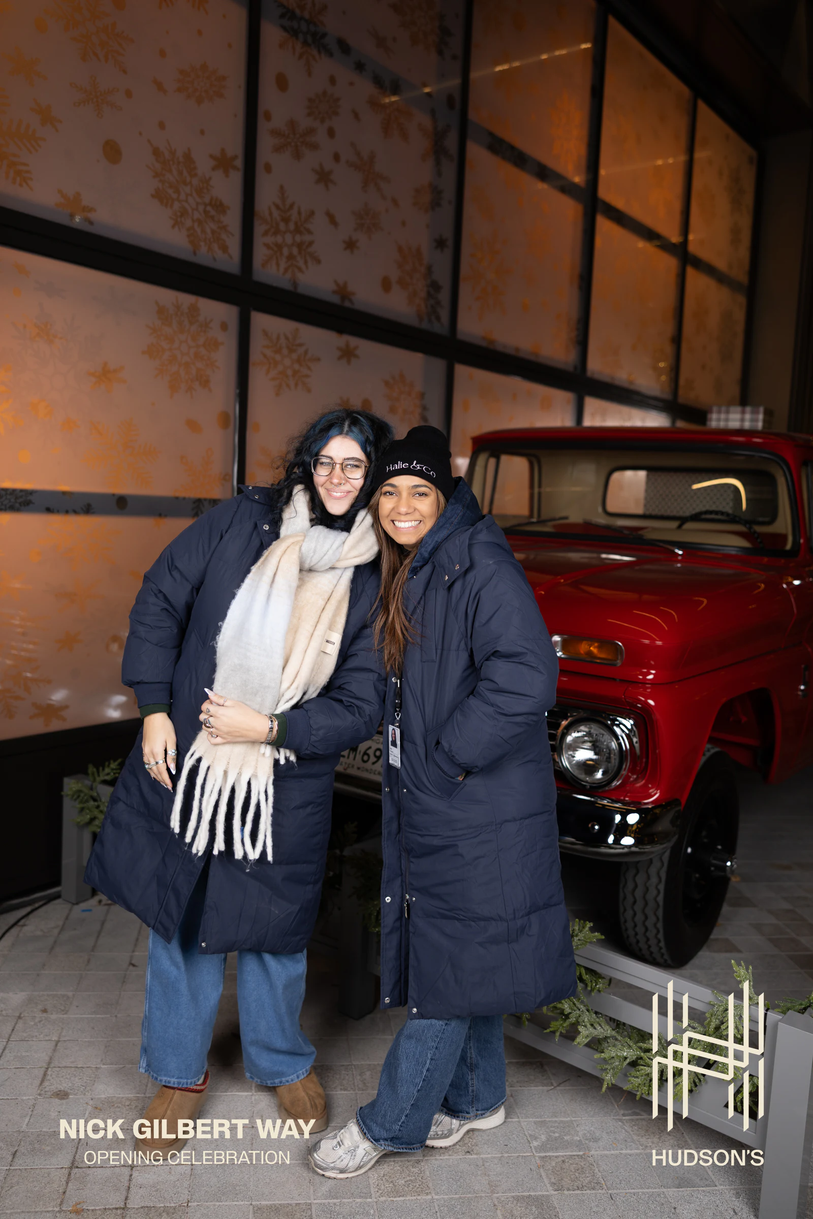 The same pair standing by the red truck, full length at Nick Gilbert Way Opening Celebration