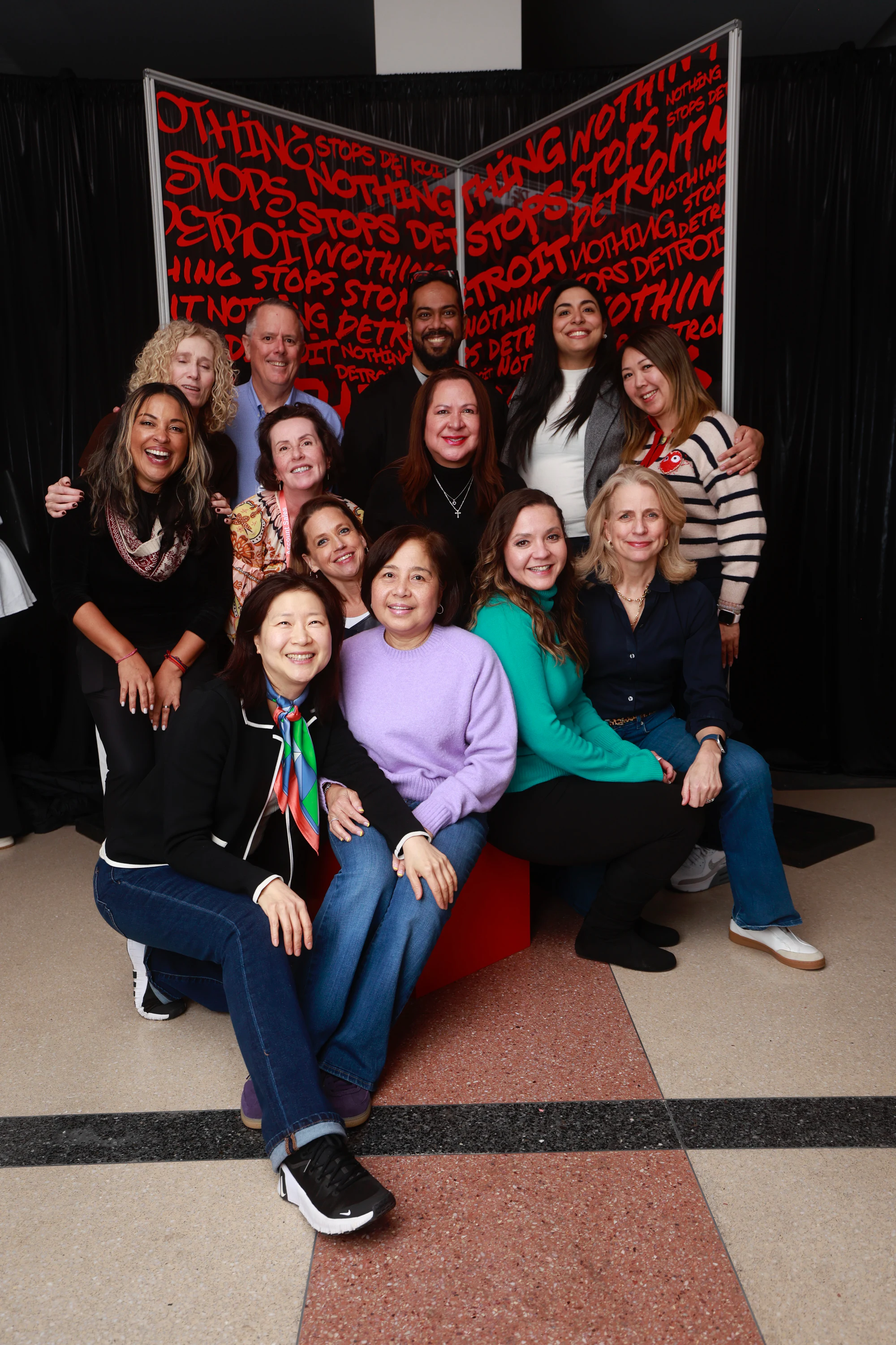 Twelve-person group, seated and standing at Nothing Stops Detroit