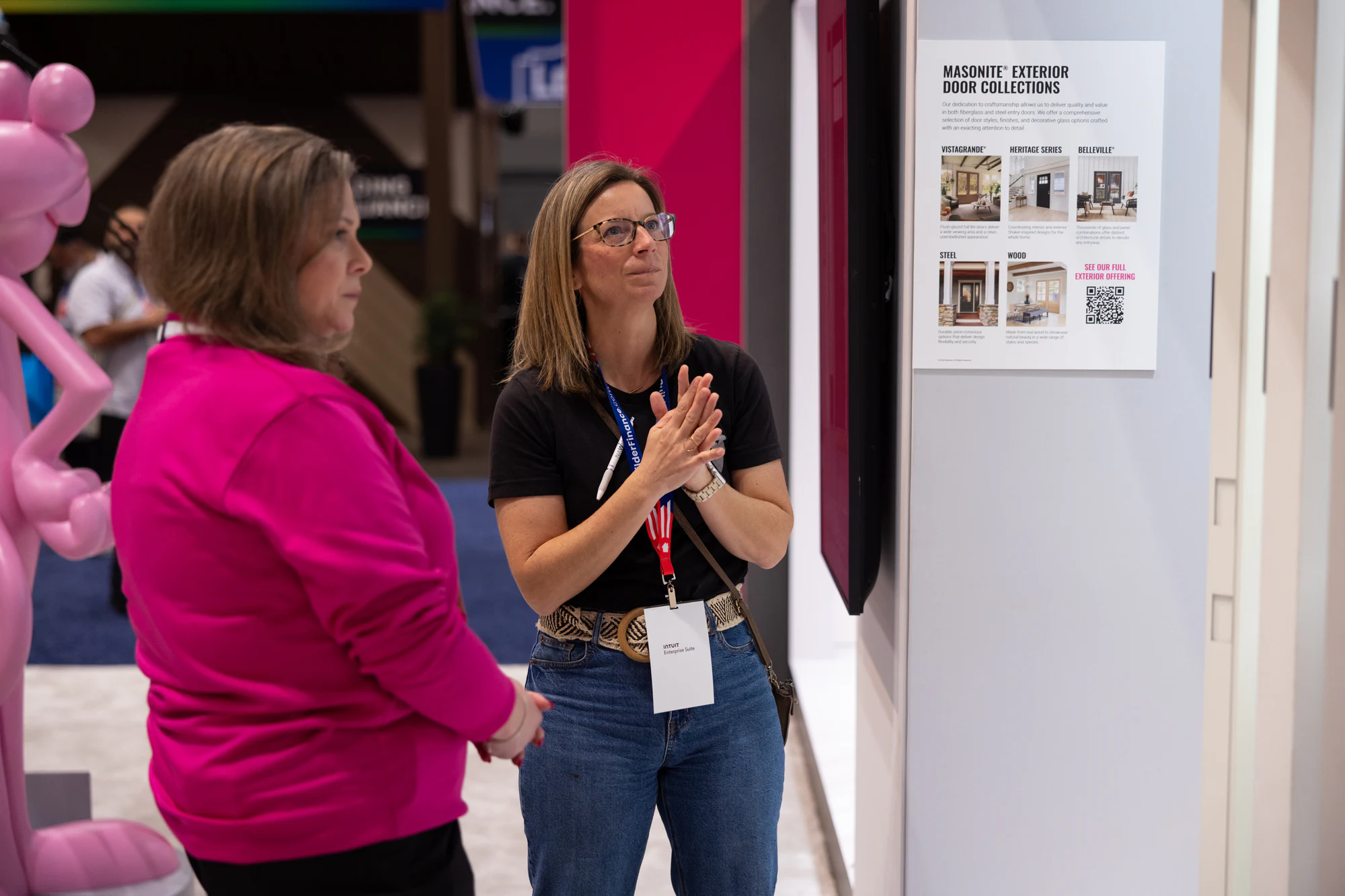 Crew member presenting to the aisle, hands mid-clap at Owens Corning at IBS 2026