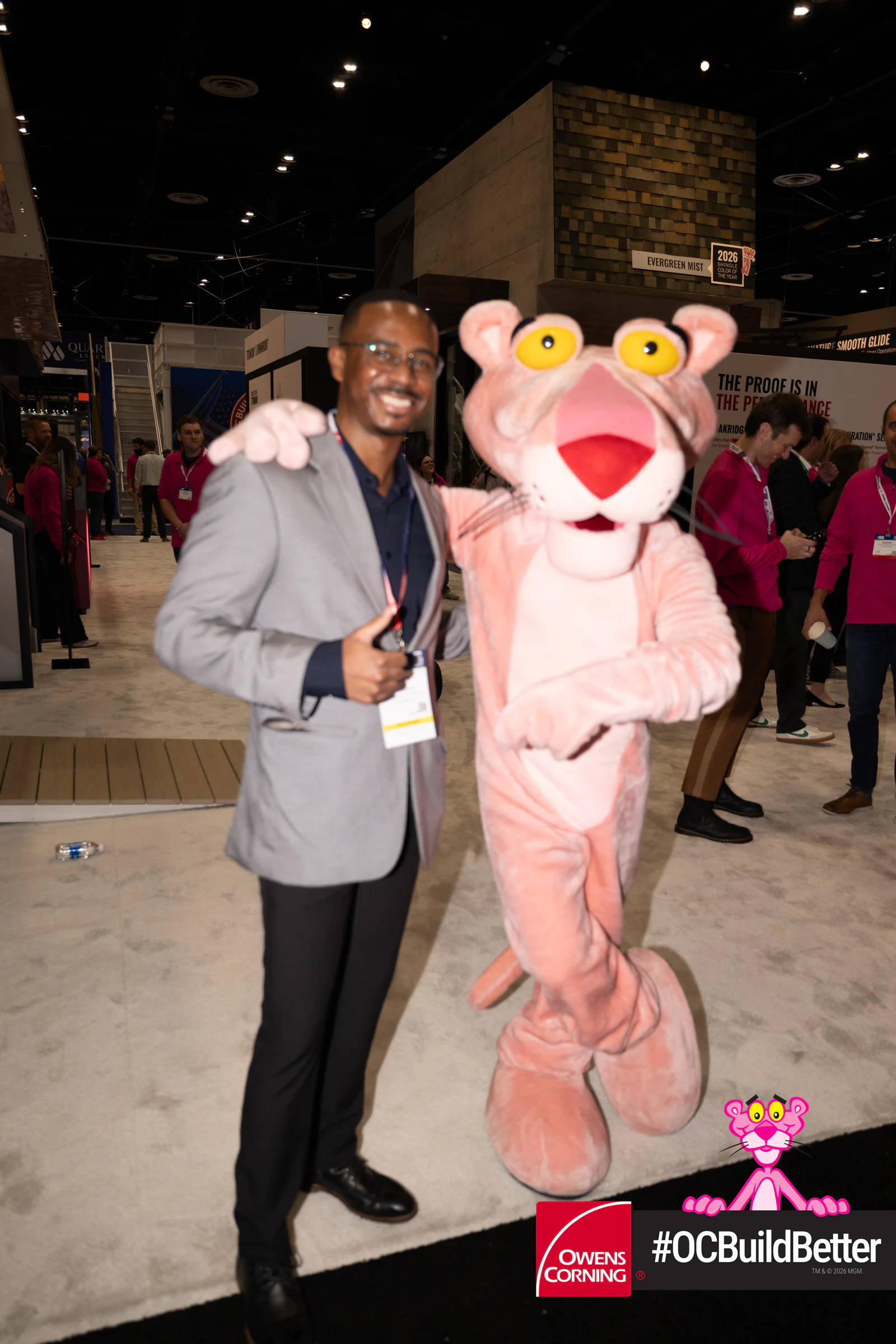 Two men with the Panther, thumbs up at Owens Corning at IBS 2026