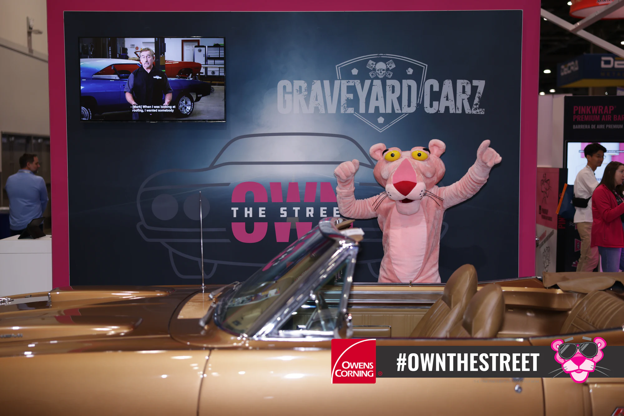 The Pink Panther sitting in the convertible itself at Owens Corning at IRE 2024